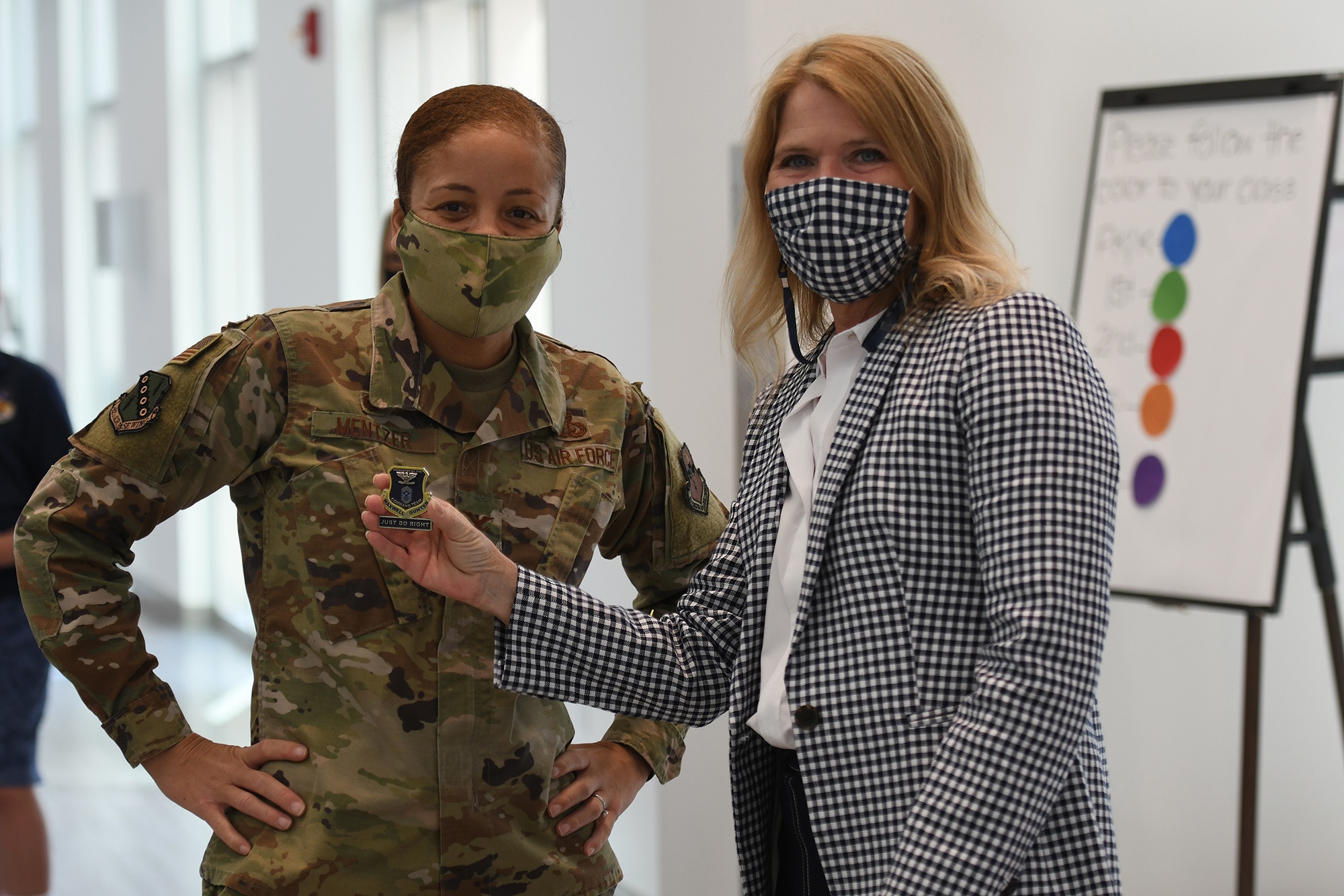 Col. Eries Mentzer, 42nd Air Base Wing Commander, coins Jamie Pittman, Principal of Maxwell Elementary and Middle School, April 27, 2021. The school is recognised as a Blue Ribbon School for achievements in academic excellence, an advanced cirriculum, and modern facilities.