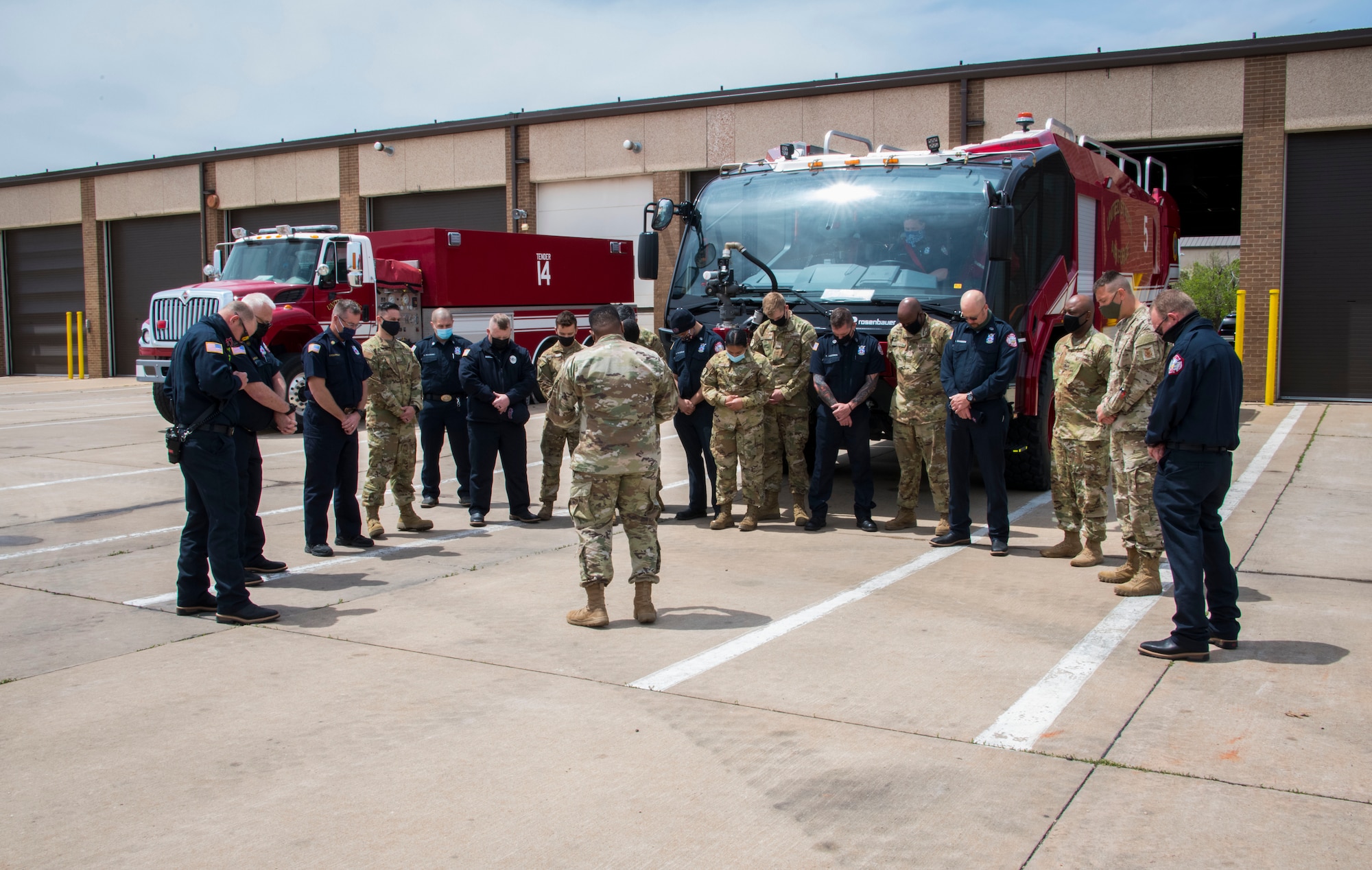 Capt. Ladron Thomas, 97th Air Mobility Wing chaplain, prays over Airmen, April 26, 2021, at Altus Air Force Base, Oklahoma. Following tradition, Thomas blessed the firefighters who would operate the truck, emphasizing the truck's ability to assist them while doing their job. (U.S. Air Force photo by Airman 1st Class Amanda Lovelace)