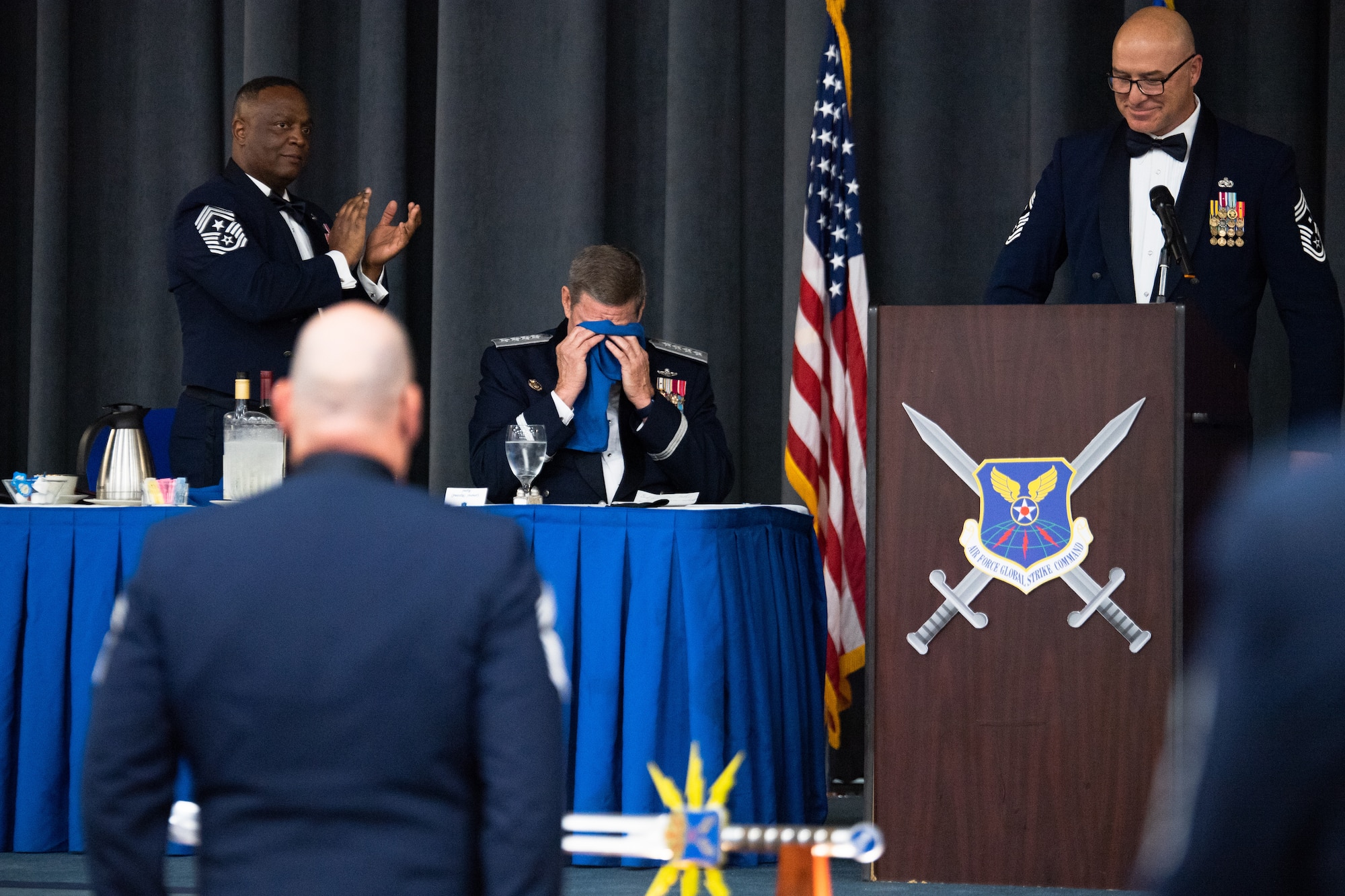 Retired Gen. Robin Rand, former Air Force Global Strike Command commander, wipes tears from his eyes after being honored at an Order of the Sword ceremony at Barksdale Air Force Base, Louisiana, April 23, 2021. The Order of the Sword is an Air Force tradition in which members of the enlisted corps recognize and honor senior officers and civilians who have made significant contributions to the welfare and prestige of the enlisted corps. (U.S. Air Force photo by Airman 1st Class Jacob B. Wrightsman)