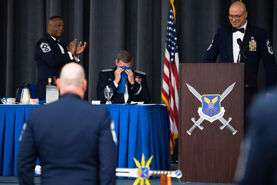 Retired Gen. Robin Rand, former Air Force Global Strike Command commander, wipes tears from his eyes after being honored at an Order of the Sword ceremony at Barksdale Air Force Base, Louisiana, April 23, 2021. The Order of the Sword is an Air Force tradition in which members of the enlisted corps recognize and honor senior officers and civilians who have made significant contributions to the welfare and prestige of the enlisted corps. (U.S. Air Force photo by Airman 1st Class Jacob B. Wrightsman)