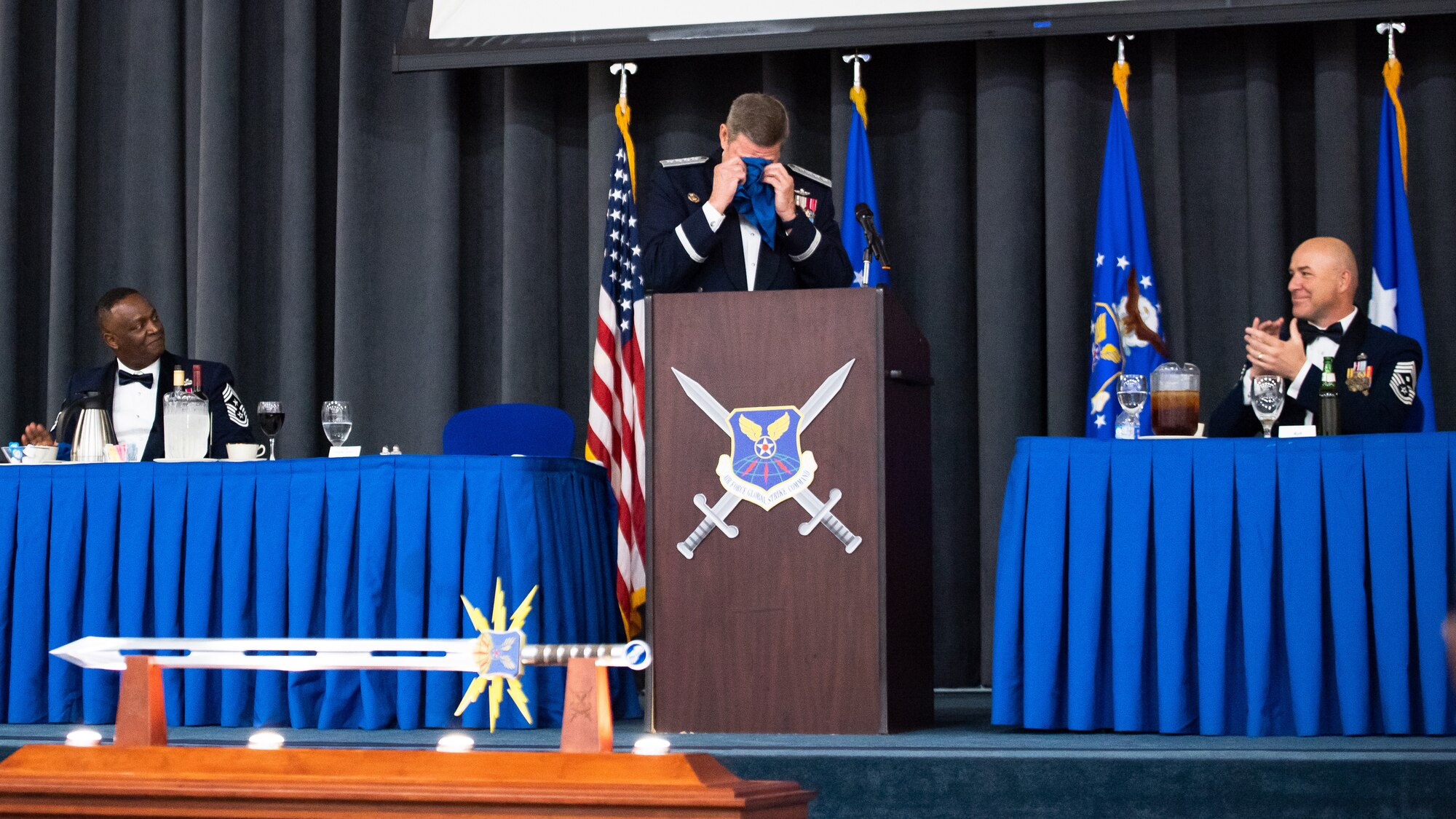 Retired Gen. Robin Rand, former Air Force Global Strike Command commander, wipes tears from his eyes after being honored at an Order of the Sword ceremony at Barksdale Air Force Base, Louisiana, April 23, 2021. The Order of the Sword is an Air Force tradition in which members of the enlisted corps recognize and honor senior officers and civilians who have made significant contributions to the welfare and prestige of the enlisted corps. (U.S. Air Force photo by Airman 1st Class Jacob B. Wrightsman)