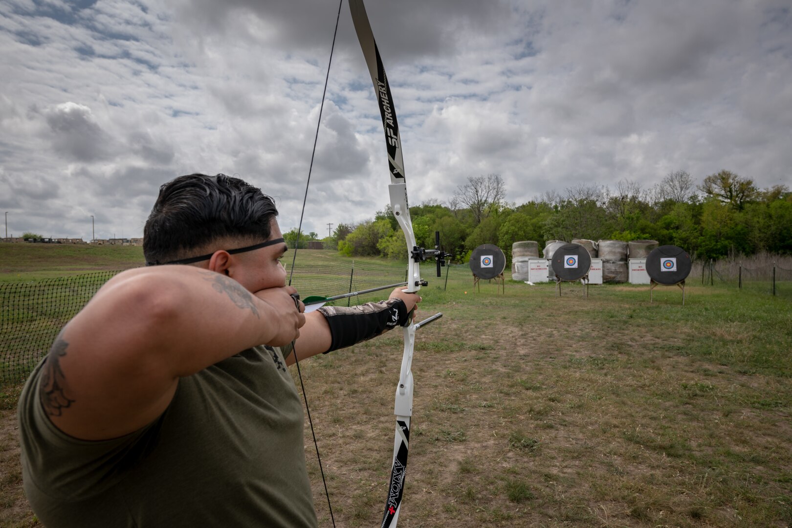 U.S. Marine Cpl. Joseph Quintanilla shoots his bow as part of the Wounded Warrior archery competition practice and bow fitting.