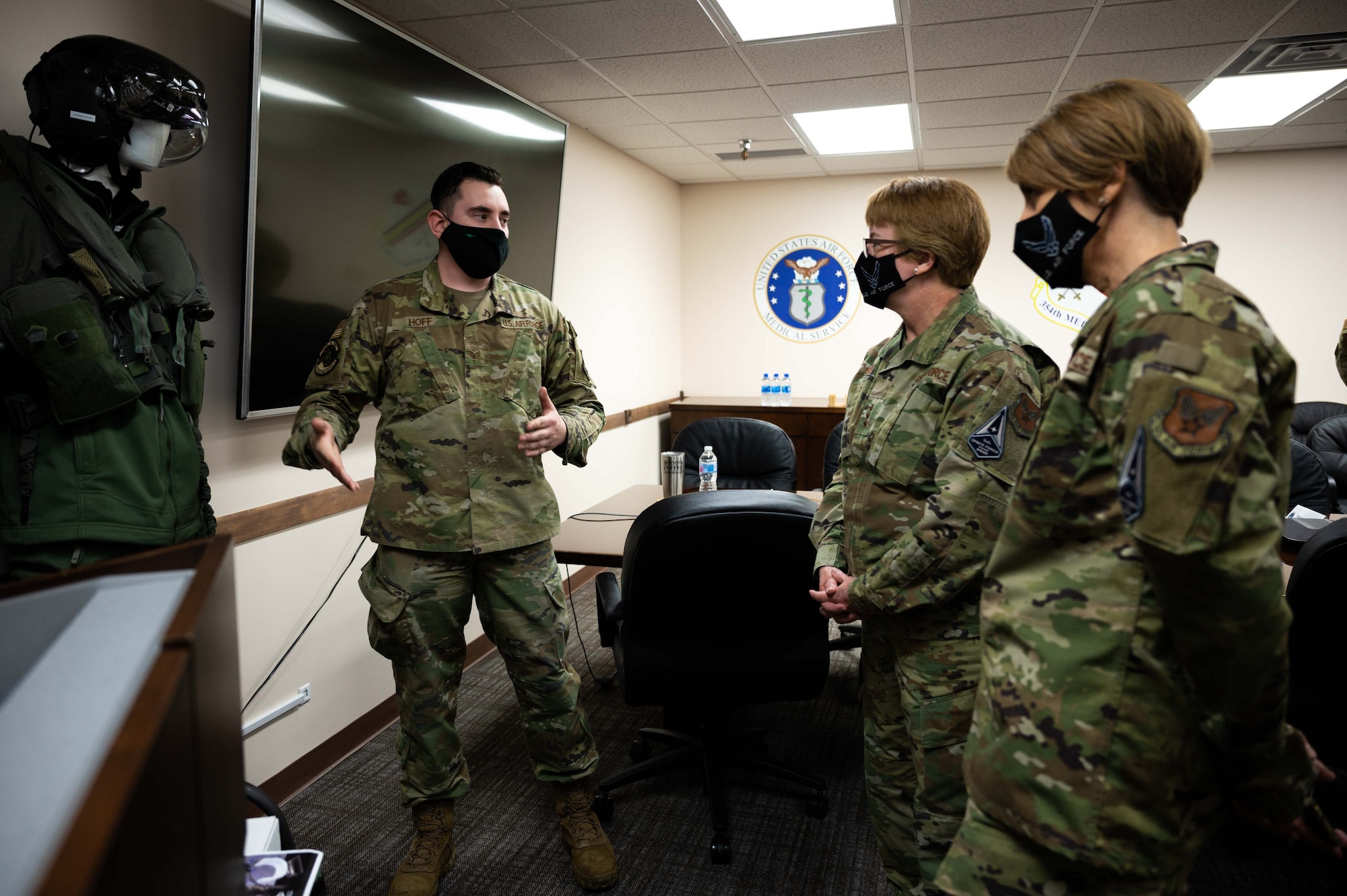 U.S. Air Force Staff Sgt. Evan Hoff, a 355th Fighter Squadron Aircrew Flight Equipment (AFE) craftsman, talks to Lt. Gen. Dorothy A. Hogg, Air Force Surgeon General, and Chief Master Sgt. Dawn Kolczynski, Chief, Medical Enlisted Force and Enlisted Corps Chief, about F-35 flight equipment during a leadership visit at Eielson Air Force Base, Alaska, April 27, 2021.