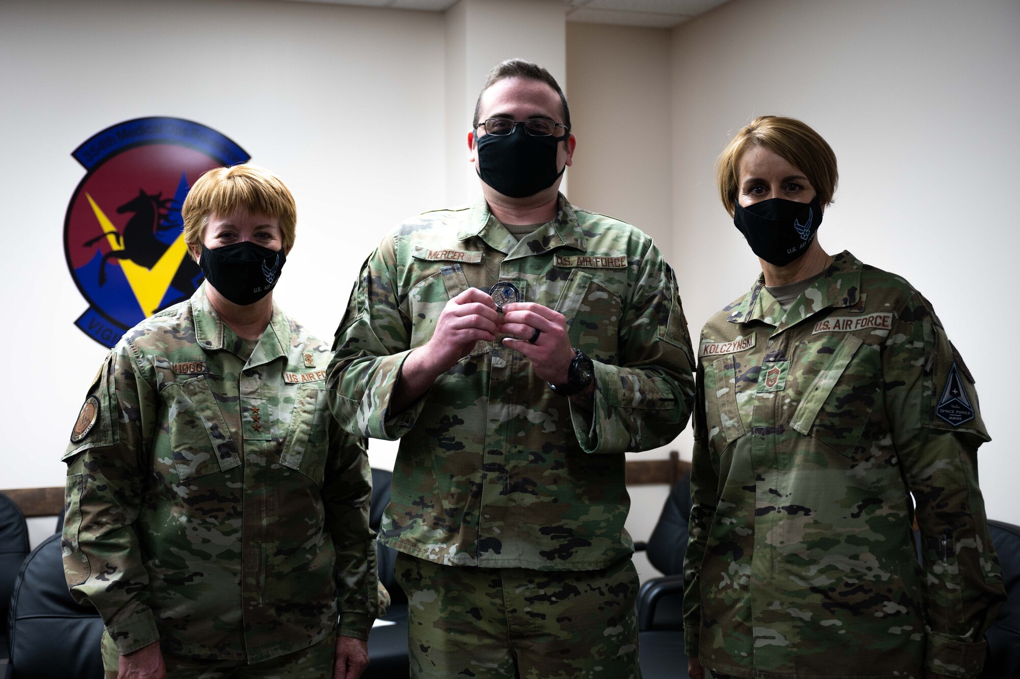 U.S. Air Force Lt. Gen. Dorothy A. Hogg, Air Force Surgeon General, Staff Sgt. Brandon Mercer, a 356th Fighter Squadron Independent Duty Medical Technician (IDMT), and Chief Master Sgt. Dawn Kolczynski, Chief, Medical Enlisted Force and Enlisted Corps Chief, pose for a photo during a leadership visit at Eielson Air Force Base, Alaska, April 27, 2021.