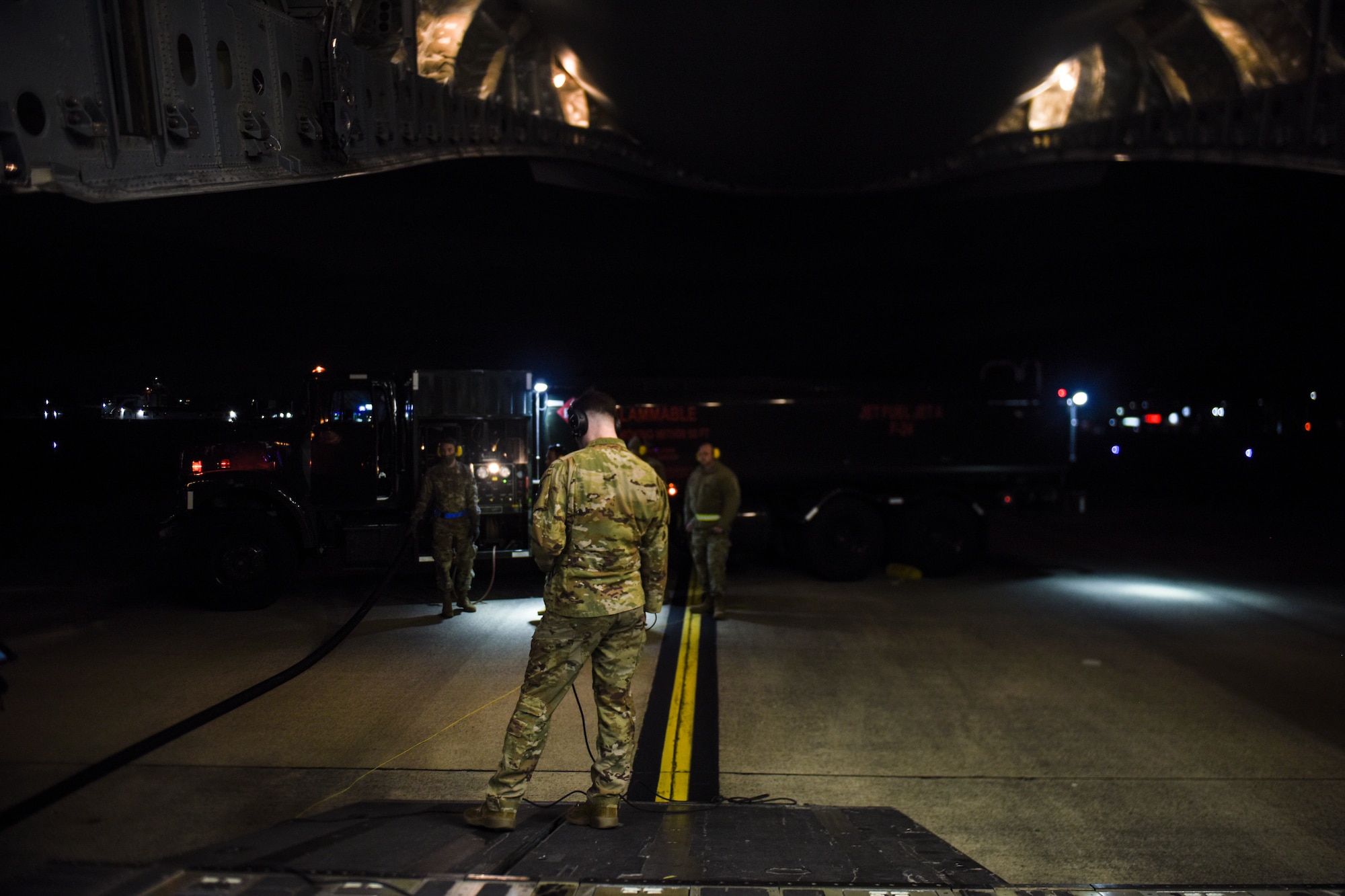 U.S. Air Force Senior Airman Justin Thompson, 4th Airlift Squadron tactician conducts a wet-wing defuel procedure on a C-17 Globemaster III in support of Exercise Rainier War at Joint Base Lewis-McChord, Washington, April 27, 2021. Rainier War tests the 62nd Airlift Wing's capability to plan, generate and execute a deployment tasking, sustain contingency operations, demonstrate full spectrum readiness while executing agile combat employment in a contested, degraded and operationally limited environment. (U.S. Air Force photo by Master Sgt. Julius Delos Reyes)