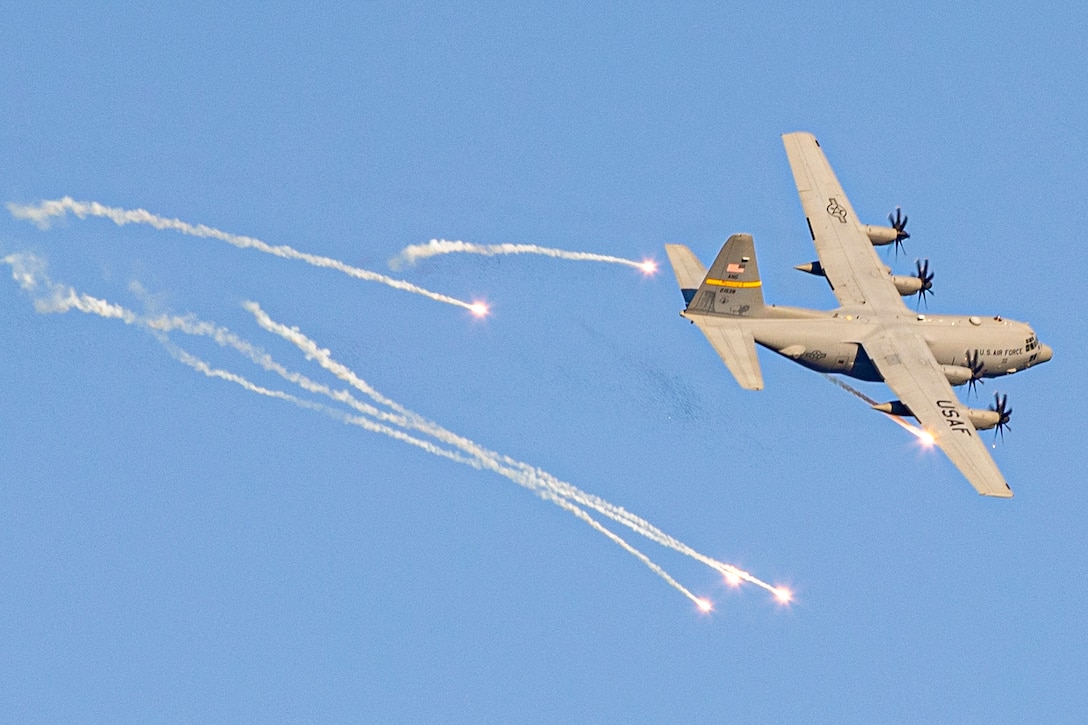An aircraft fires flares midair.