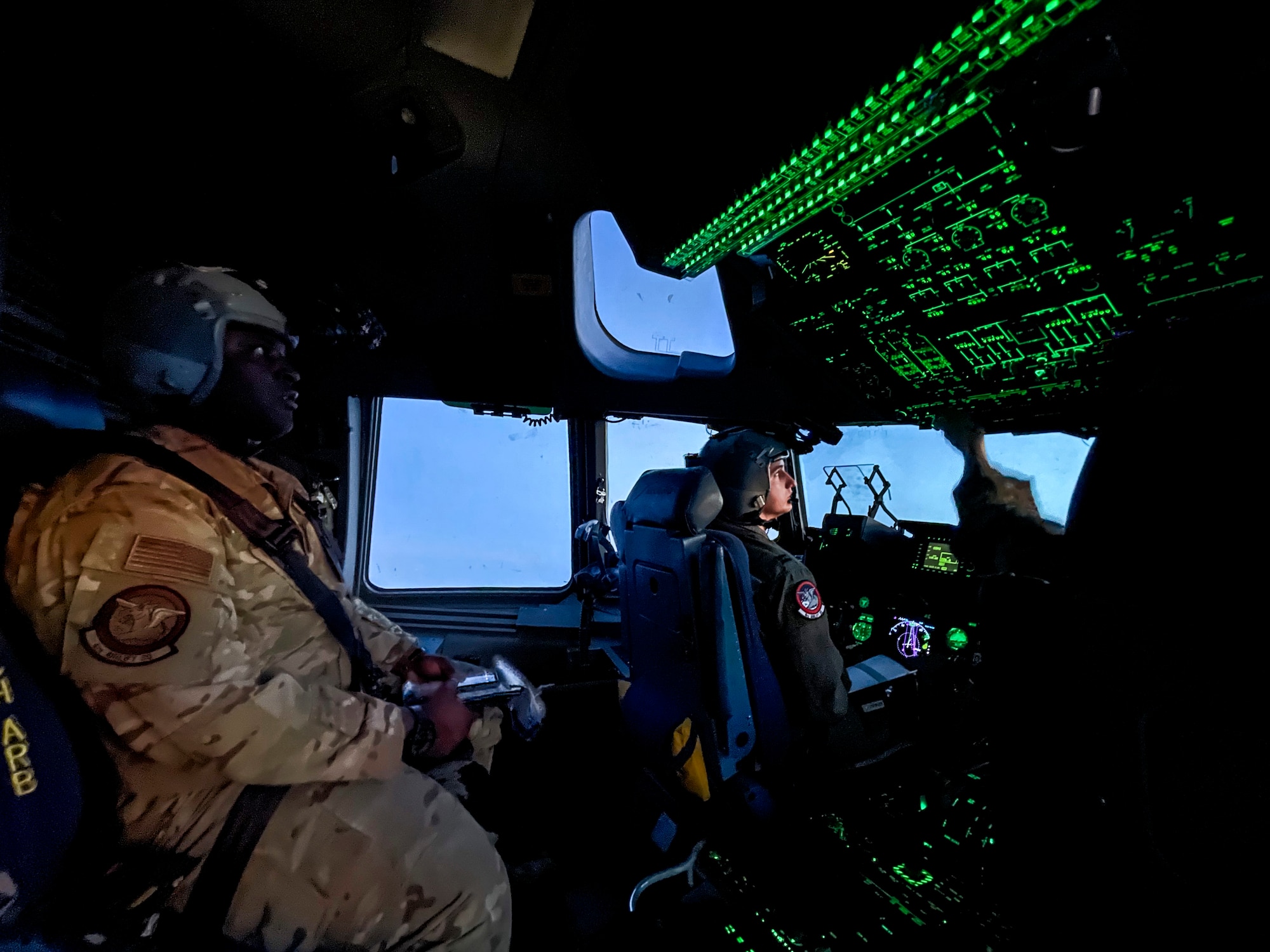 U.S. Air Force Capt. Wes Cobb, 4th Airlift Squadron (4th AS) instructor pilot and flight commander, observes as Capt. Ryan Pattman, 4th AS tactics officer and aircraft commander, pilots a C-17 Globemaster III following an airlift mission in support of Exercise Rainier War at Yakima, Washington, April 27, 2021. Rainier War tests the 62nd Airlift Wing's capability to plan, generate and execute a deployment tasking, sustain contingency operations, demonstrate full spectrum readiness while executing agile combat employment in a contested, degraded and operationally limited environment. (U.S. Air Force photo by Master Sgt. Julius Delos Reyes)