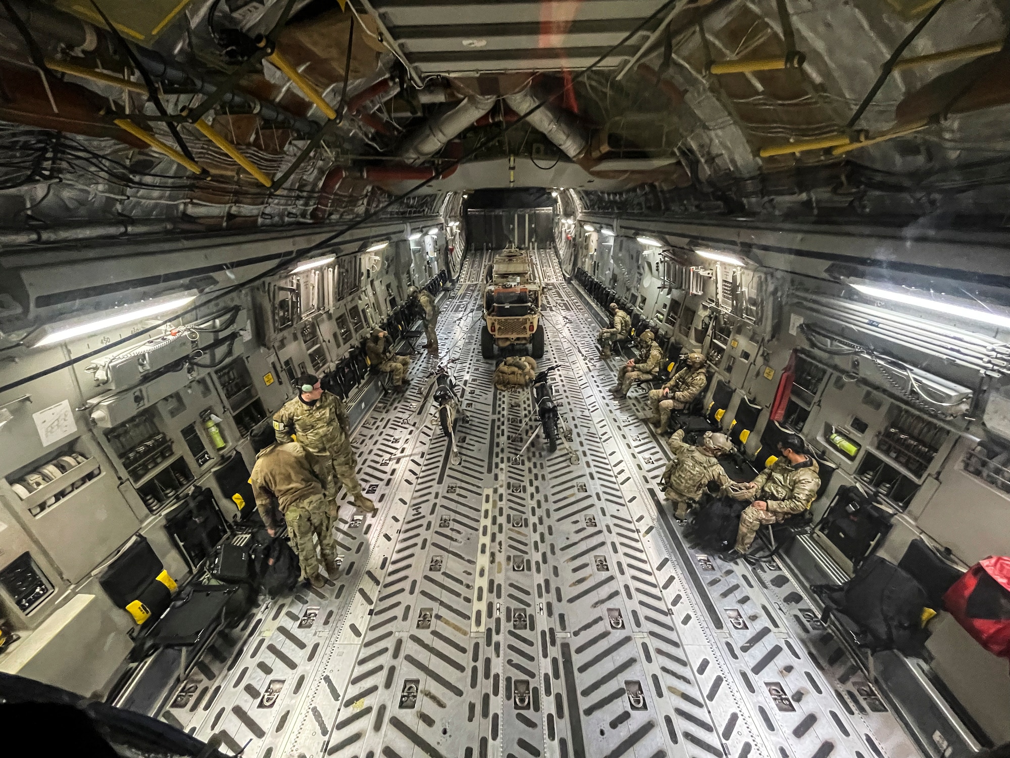 U.S. Air Force Airmen with the 22ndt Special Tactics Squadron board a Team McChord C-17 Globemaster III during Exercise Ranier War at Joint Base Lewis-McChord, Washington, April 27, 2021. Rainier War tests the 62nd Airlift Wing's capability to plan, generate and execute a deployment tasking, sustain contingency operations, demonstrate full spectrum readiness while executing agile combat employment in a contested, degraded and operationally limited environment. (U.S. Air Force photo by Master Sgt. Julius Delos Reyes)