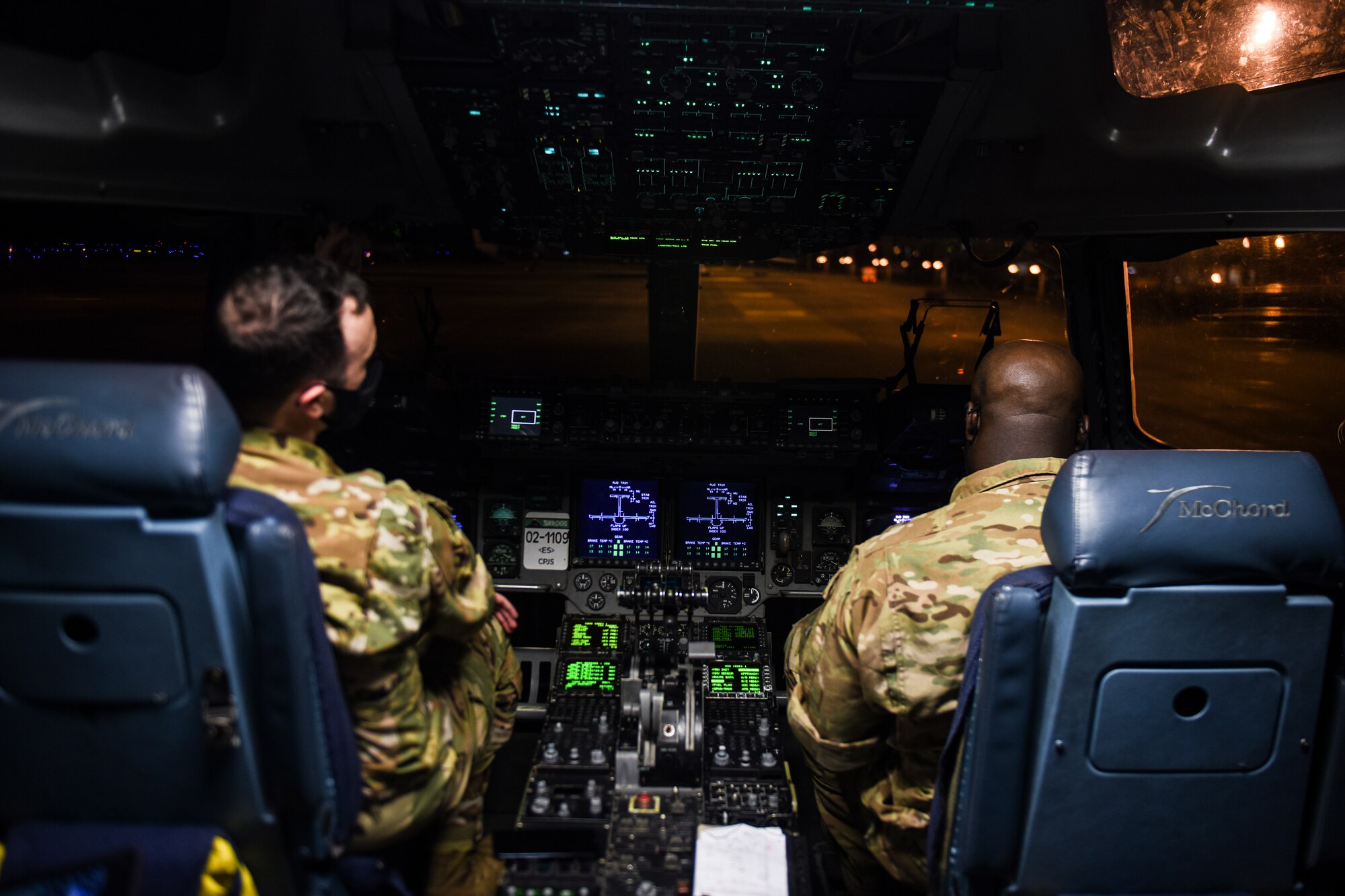 From left, U.S. Air Force 1st Lt. Garrett Matney, 4th Airlift Squadron (4th AS) co-pilot, and Capt. Wes Cobb, 4th AS instructor pilot and flight commander, prepare for an airlift mission as part of Exercise Rainier War at Joint Base Lewis-McChord, Washington, April 26, 2021. Rainier War tests the 62nd Airlift Wing's capability to plan, generate and execute a deployment tasking, sustain contingency operations, demonstrate full spectrum readiness while executing agile combat employment in a contested, degraded and operationally limited environment. (U.S. Air Force photo by Master Sgt. Julius Delos Reyes)