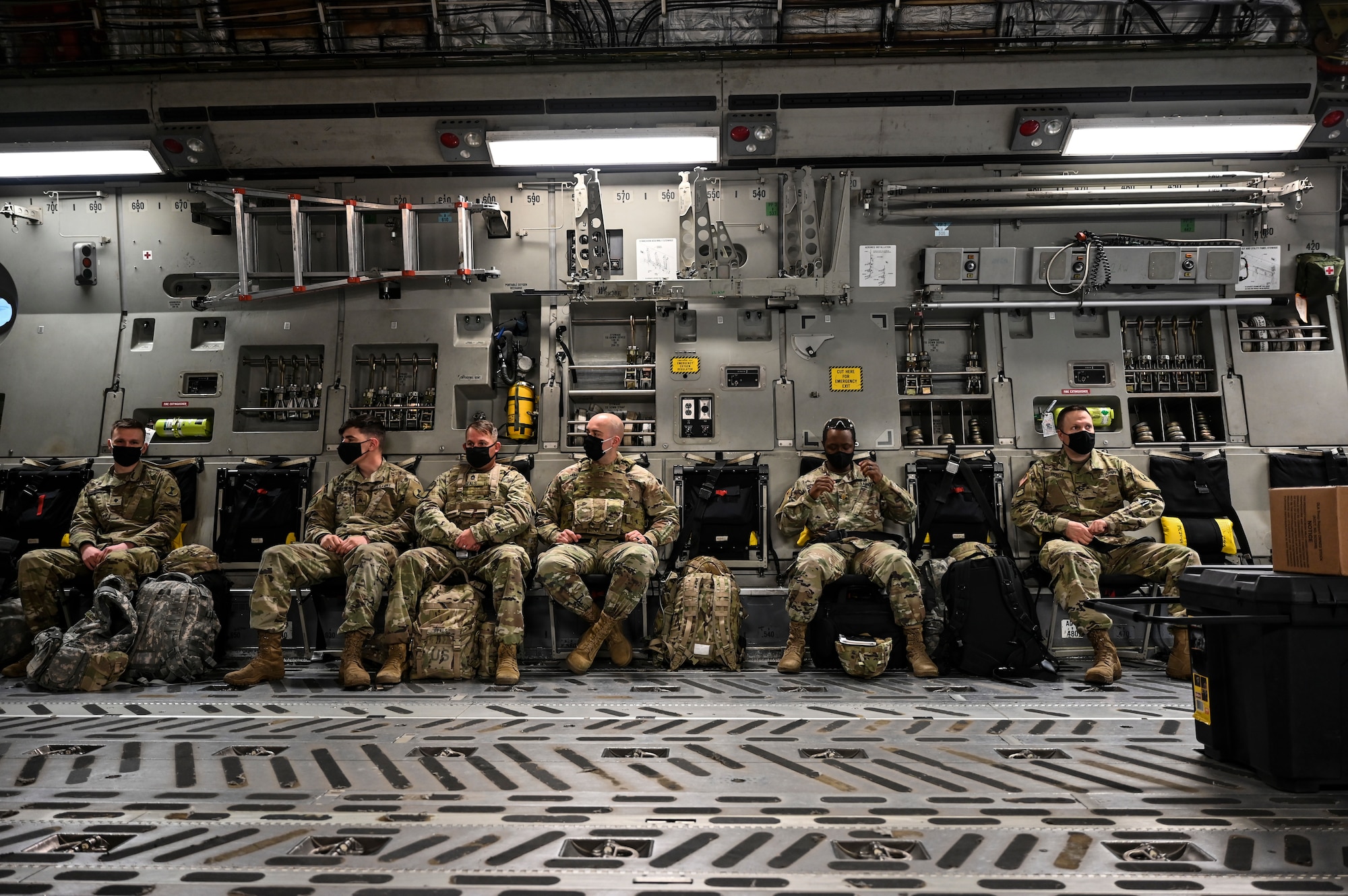 U.S. Army Soldiers with the 7th Infantry Division wait for their departure aboard a C-17 Globemaster III as part of Exercise Rainier War at Joint Base Lewis-McChord, Washington, April 28, 2021. Rainier War tests the 62nd Airlift Wing's capability to plan, generate and execute a deployment tasking, sustain contingency operations, demonstrate full spectrum readiness while executing agile combat employment in a contested, degraded and operationally limited environment. (U.S. Air Force photo by Master Sgt. Julius Delos Reyes)