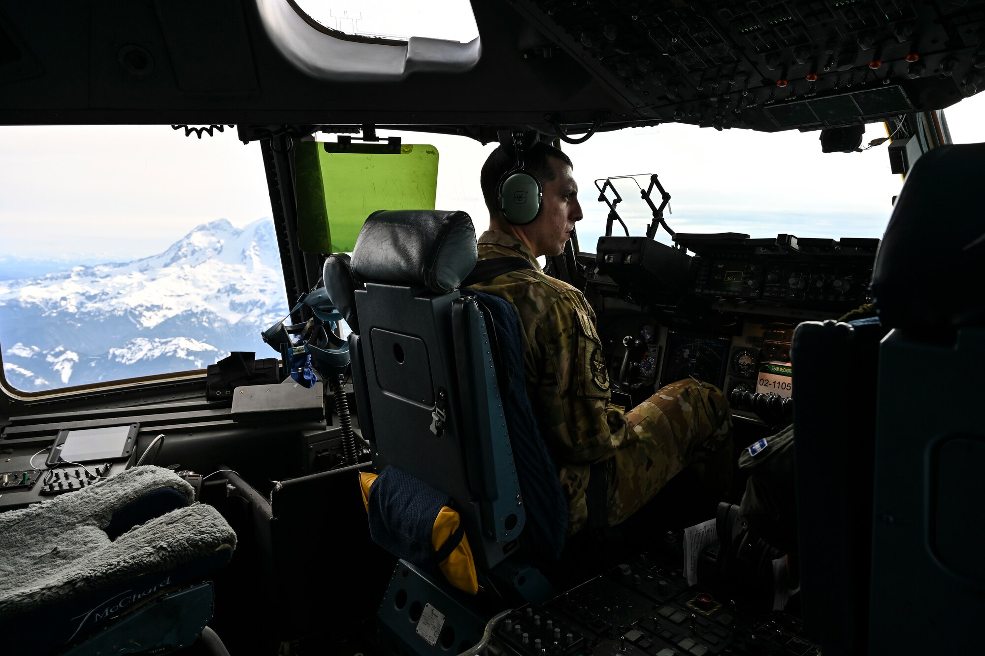 U.S. Air Force Capt. Chris Rolon, 62nd Operations Support Squadron aircraft commander, flies a C-17 Globemaster III over Mount Rainier as part of Exercise Rainier War at Joint Base Lewis-McChord, Washington, April 28, 2021. Rainier War tests the 62nd Airlift Wing's capability to plan, generate and execute a deployment tasking, sustain contingency operations, demonstrate full spectrum readiness while executing agile combat employment in a contested, degraded and operationally limited environment. (U.S. Air Force photo by Master Sgt. Julius Delos Reyes)