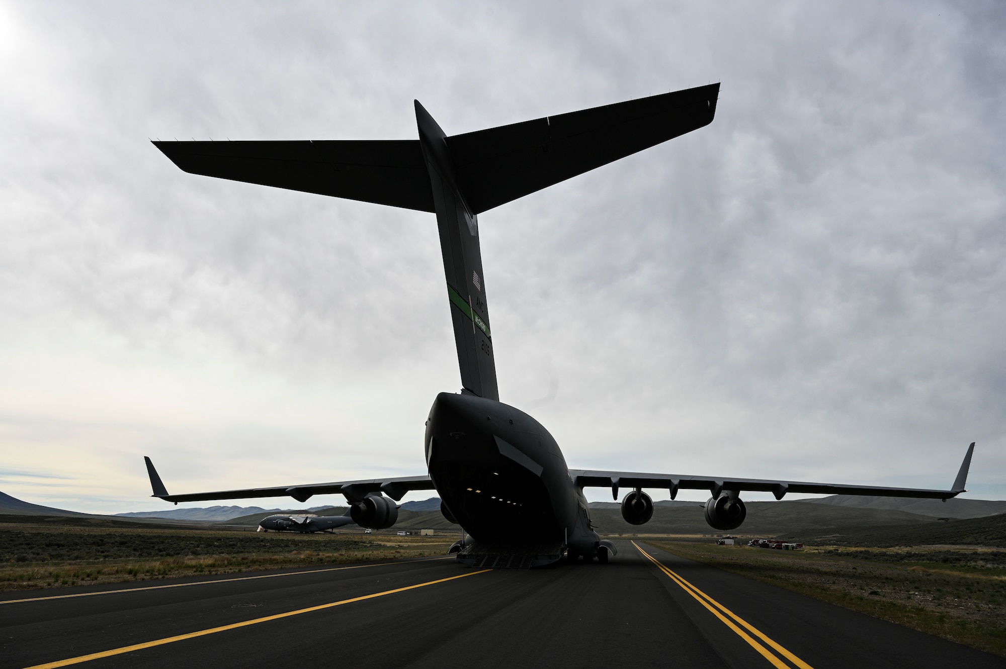 A C-17 Globemaster III sits at Yakima, Washington, April 28, 2021, after dropping off U.S. Army 7th Infantry Division Soldiers as part of Exercise Rainier War. The exercise tests the 62nd Airlift Wing's capability to plan, generate and execute a deployment tasking, sustain contingency operations, demonstrate full spectrum readiness while executing agile combat employment in a contested, degraded and operationally limited environment. (U.S. Air Force photo by Master Sgt. Julius Delos Reyes)