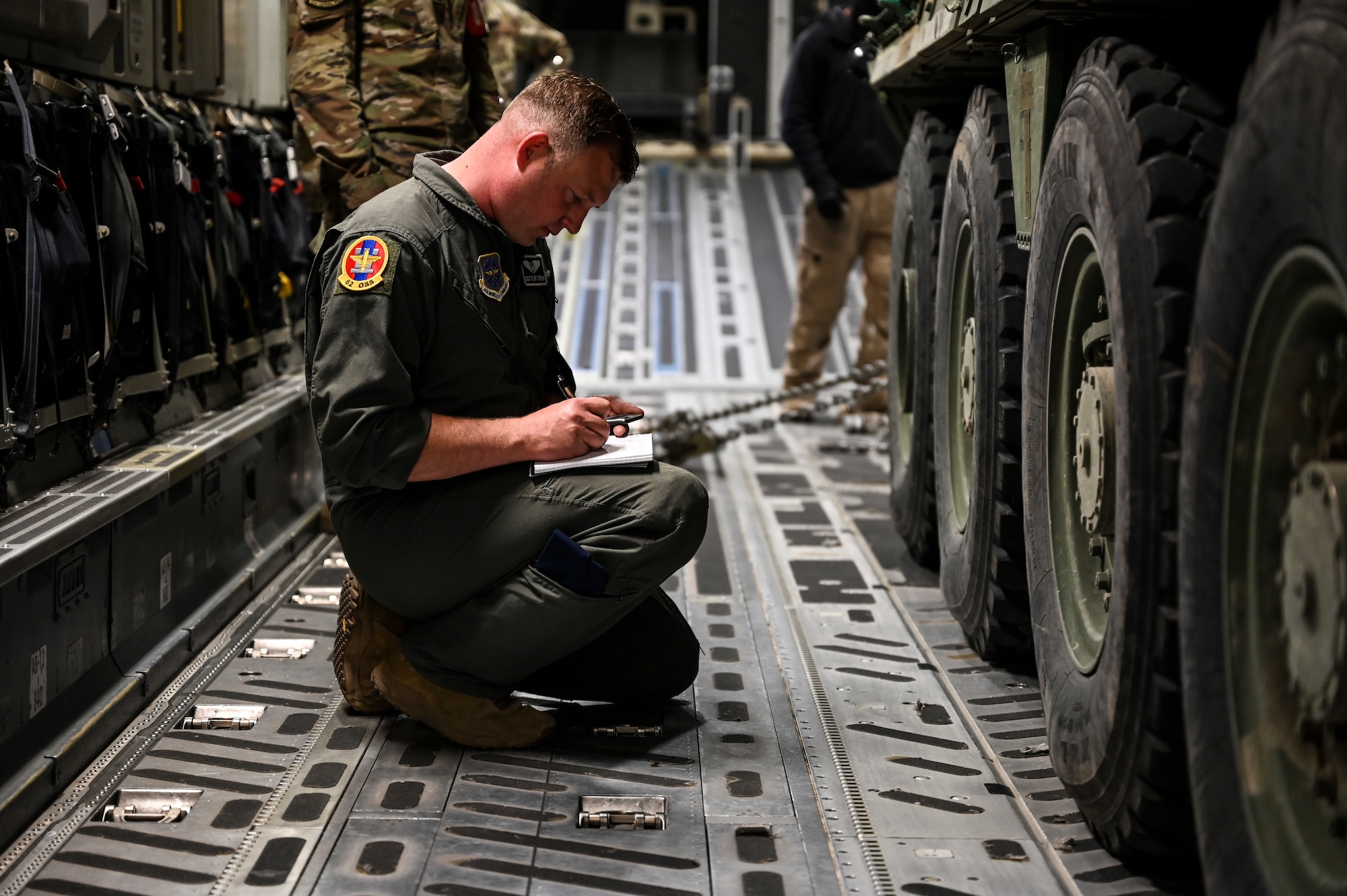 U.S. Air Force Staff Sgt. Flint Yerian, 8th Airlift Squadron loadmaster, checks the weight of a U.S. Army Stryker Infantry Carrier Vehicle aboard a C-17 Globemaster III as part of Exercise Rainier War at Joint Base Lewis-McChord, April 28, 2021. Rainier War tests the 62nd Airlift Wing's capability to plan, generate and execute a deployment tasking, sustain contingency operations, demonstrate full spectrum readiness while executing agile combat employment in a contested, degraded and operationally limited environment. (U.S. Air Force photo by Master Sgt. Julius Delos Reyes)