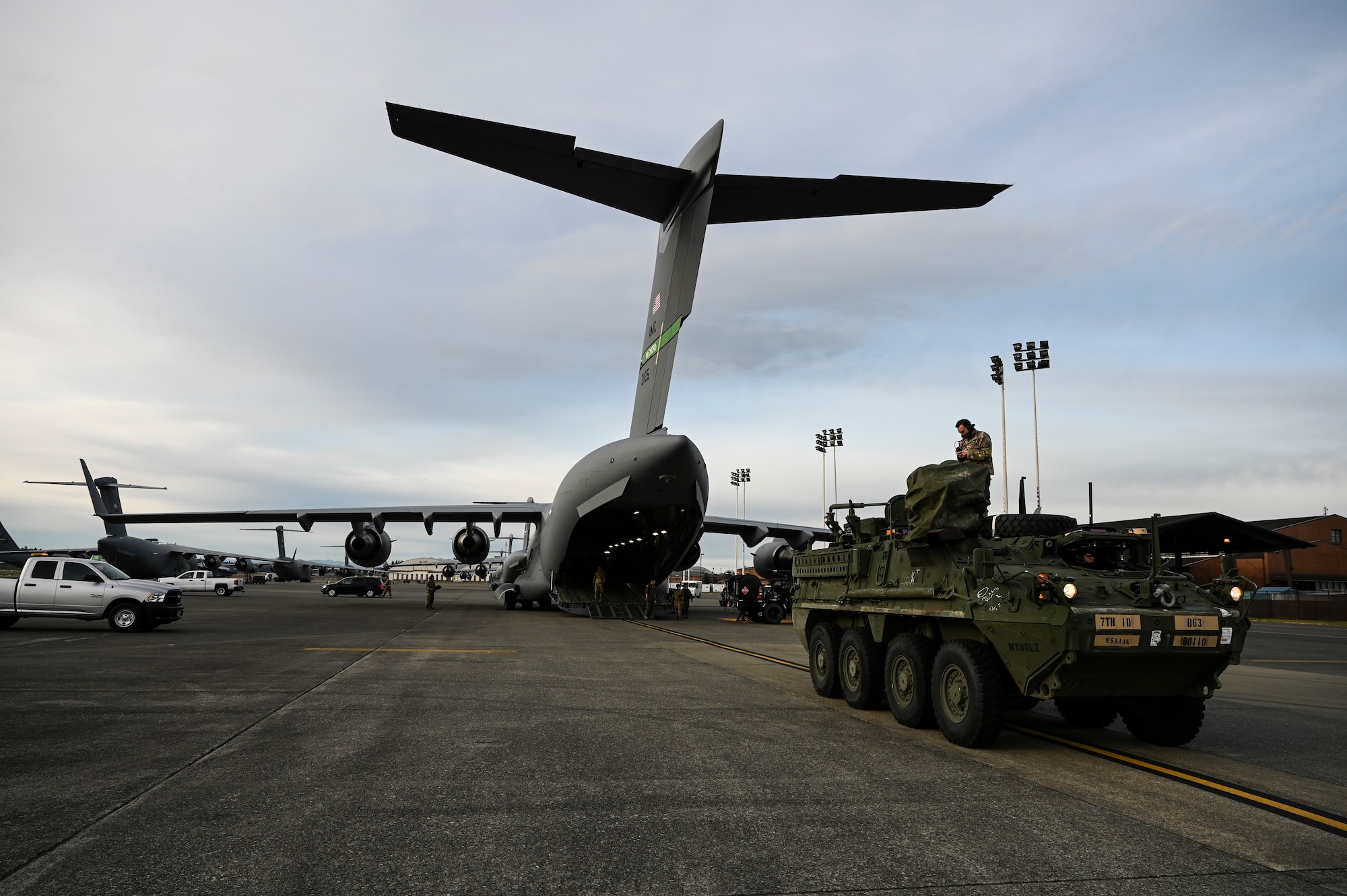 U.S. Air Force Airmen and U.S. Army Soldiers prepare to load a U.S. Army Stryker Infantry Carrier Vehicle into a C-17 Globemaster III as part of Exercise Rainier War at Joint Base Lewis-McChord, Washington, April 28, 2021. Rainier War tests the 62nd Airlift Wing's capability to plan, generate and execute a deployment tasking, sustain contingency operations, demonstrate full spectrum readiness while executing agile combat employment in a contested, degraded and operationally limited environment. (U.S. Air Force photo by Master Sgt. Julius Delos Reyes)