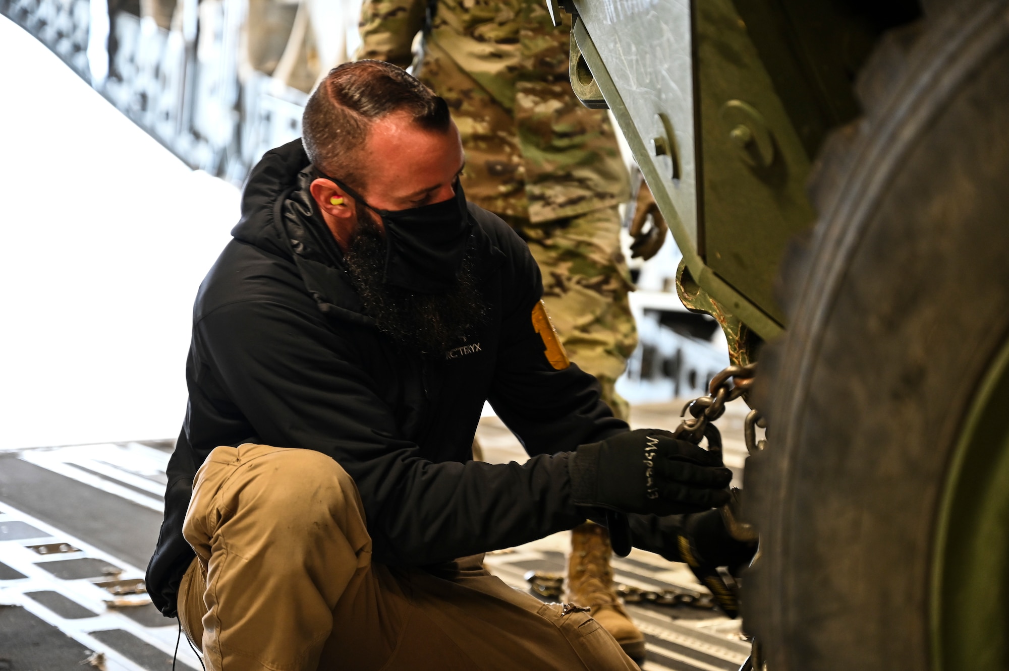 Michael Speaks, aircraft loader leader with the 62nd Aerial Port Squadron, secures a U.S. Army Stryker Infantry Carrier Vehicle aboard a C-17 Globemaster III as part of Exercise Rainier War at Joint Base Lewis-McChord, Washington, April 28, 2021. Rainier War tests the 62nd Airlift Wing's capability to plan, generate and execute a deployment tasking, sustain contingency operations, demonstrate full spectrum readiness while executing agile combat employment in a contested, degraded and operationally limited environment. (U.S. Air Force photo by Master Sgt. Julius Delos Reyes)