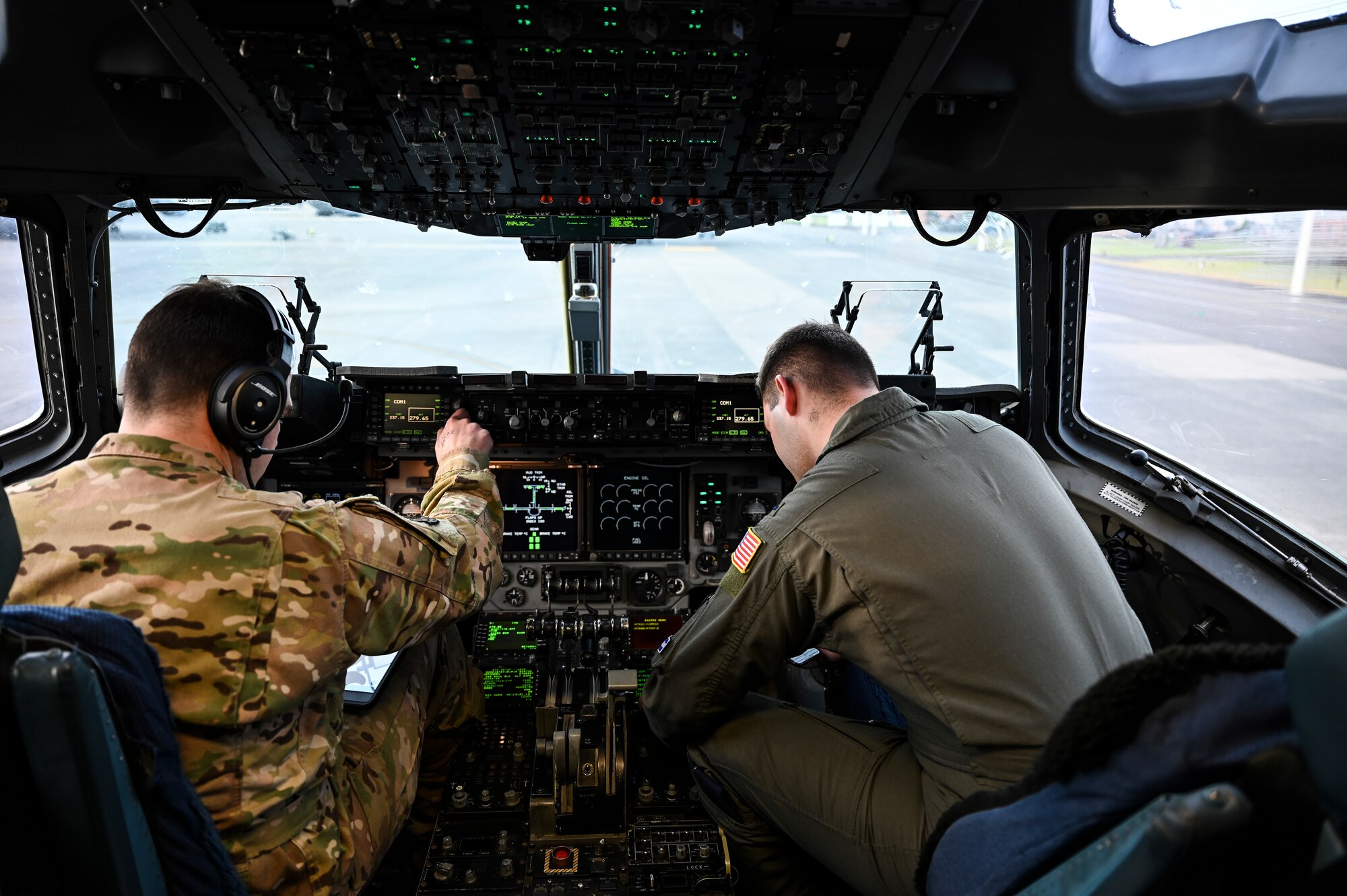 U.S. Air Force Capt. Nick Baker, left, and 1st Lt. Ian Marlin, 8th Airlift Squadron co-pilots, prepare for an airlift mission as part of Exercise Rainier War at Joint Base Lewis-McChord, Washington, April 28, 2021. Rainier War tests the 62nd Airlift Wing's capability to plan, generate and execute a deployment tasking, sustain contingency operations, demonstrate full spectrum readiness while executing agile combat employment in a contested, degraded and operationally limited environment. (U.S. Air Force photo by Master Sgt. Julius Delos Reyes)