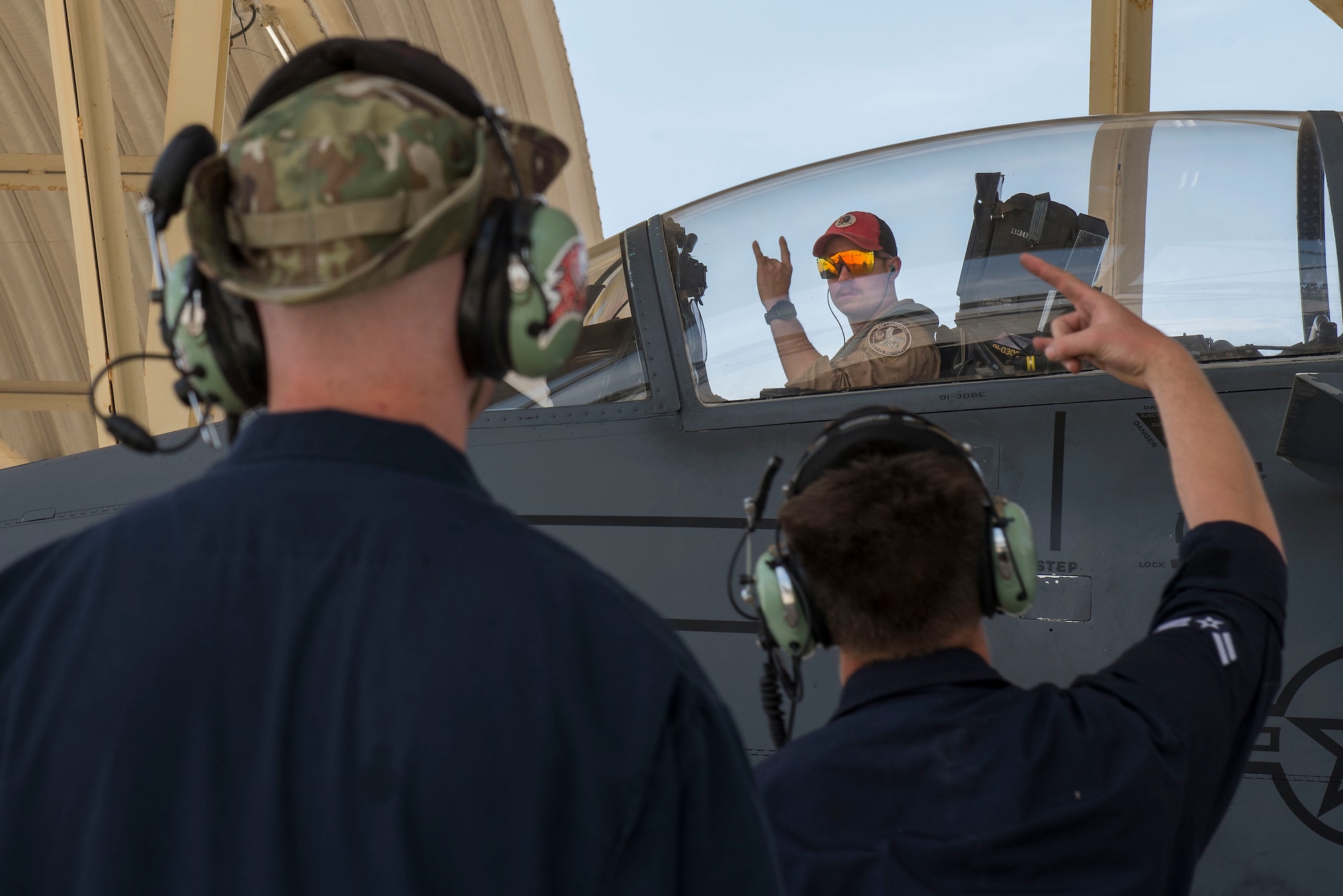 A pilot assigned to the 494th Expeditionary Fighter Squadron (EFS) greets maintenance personnel assigned to the 380th Expeditionary Maintenance Group upon arrival to Al Dhafra Air Base, United Arab Emirates, April 25, 2021.