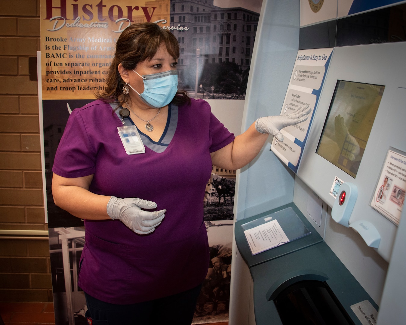 Rose Guillen, pharmacy technician, demonstrates the proper use of new express prescription kiosk at Brooke Army Medical Center.