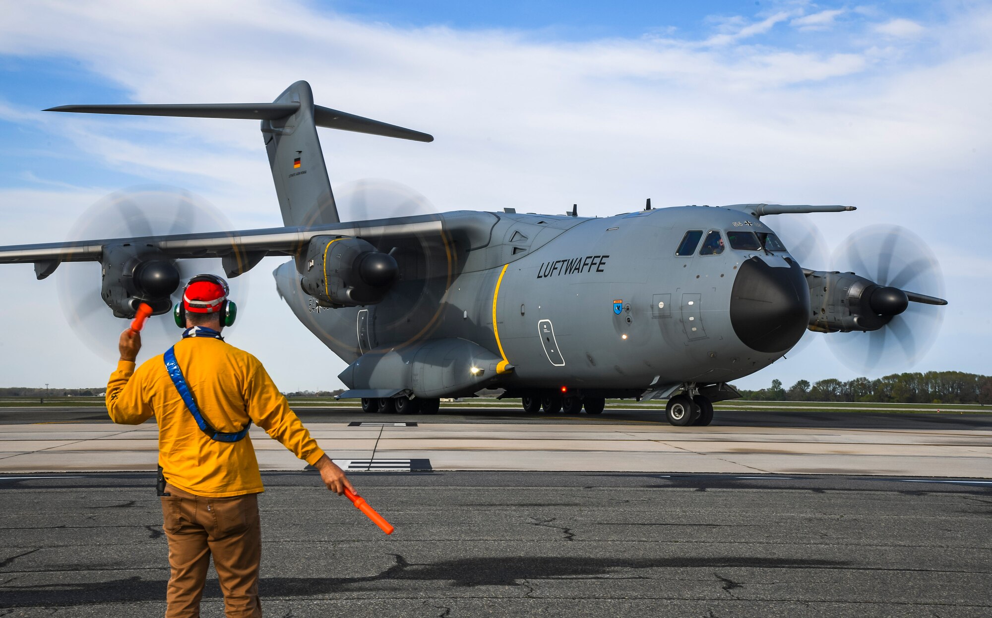 A 436th Maintenance Squadron member marshals a German air force A-400M Atlas as part of a foreign military sales mission at Dover Air Force Base, Delaware, April 19, 2021. Germany is a key NATO ally, helping to strengthen regional security and encourage peace and unity in Europe. Dover AFB’s FMS mission supports approximately $3.5 billion worth of equipment annually. (U.S. Air Force photo by Airman 1st Class Stephani Barge)