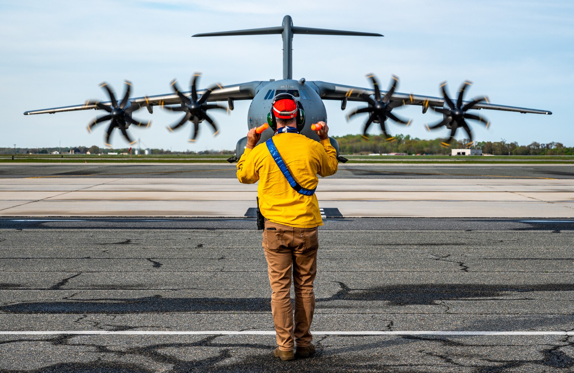 A 436th Maintenance Squadron member marshals a German air force A-400M Atlas as part of a foreign military sales mission at Dover Air Force Base, Delaware, April 19, 2021. Germany is a key NATO ally, helping to strengthen regional security and encourage peace and unity in Europe. Dover AFB’s FMS mission supports approximately $3.5 billion worth of equipment annually. (U.S. Air Force photo by Senior Airman Christopher Quail)