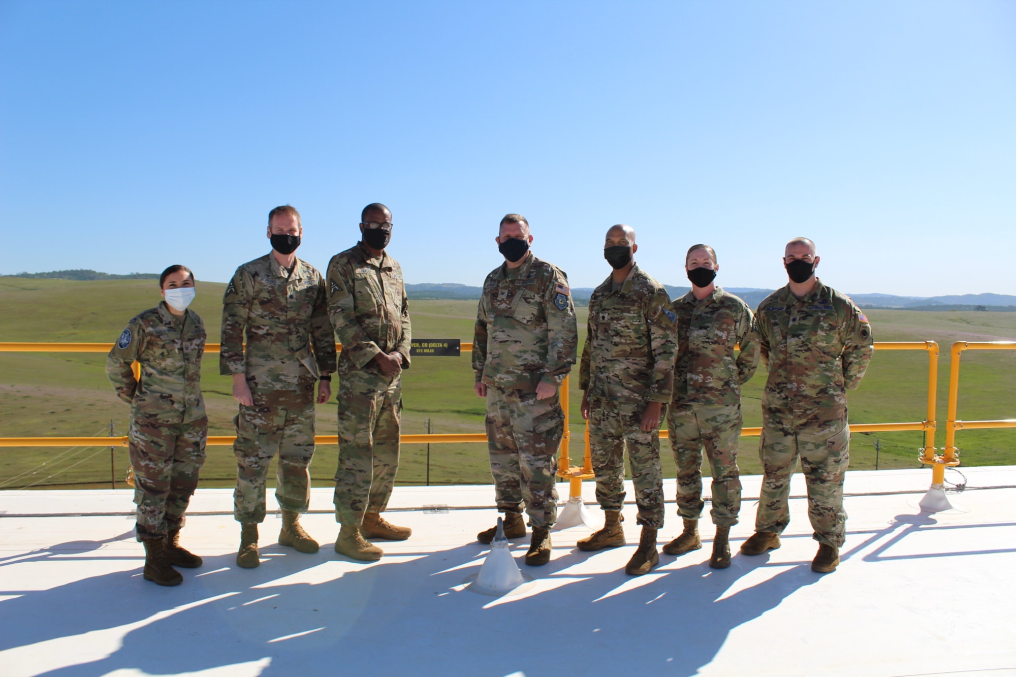 From left to right, Master Sgt. Nadia Segovia, 7 Space Warning Squadron superintendent; Lt. Col. Blake Hoagland, 7 SWS commander; Chief Master Sgt. Willie Frazier II, Space Delta 4 senior enlisted leader; Col. Richard Bourquin, DEL 4 commander, Lt. Col. Trevor Hollis, DEL 4 deputy commander; Master Sgt. Rebecca  Brown, DEL 4 first sergeant; and Lt. Col. Joshua McCullion, 7 SWS director of operations, stand next to 7 SWS's homage to DEL 4 at Beale Air Force Base, Calif., March 29, 2021.
