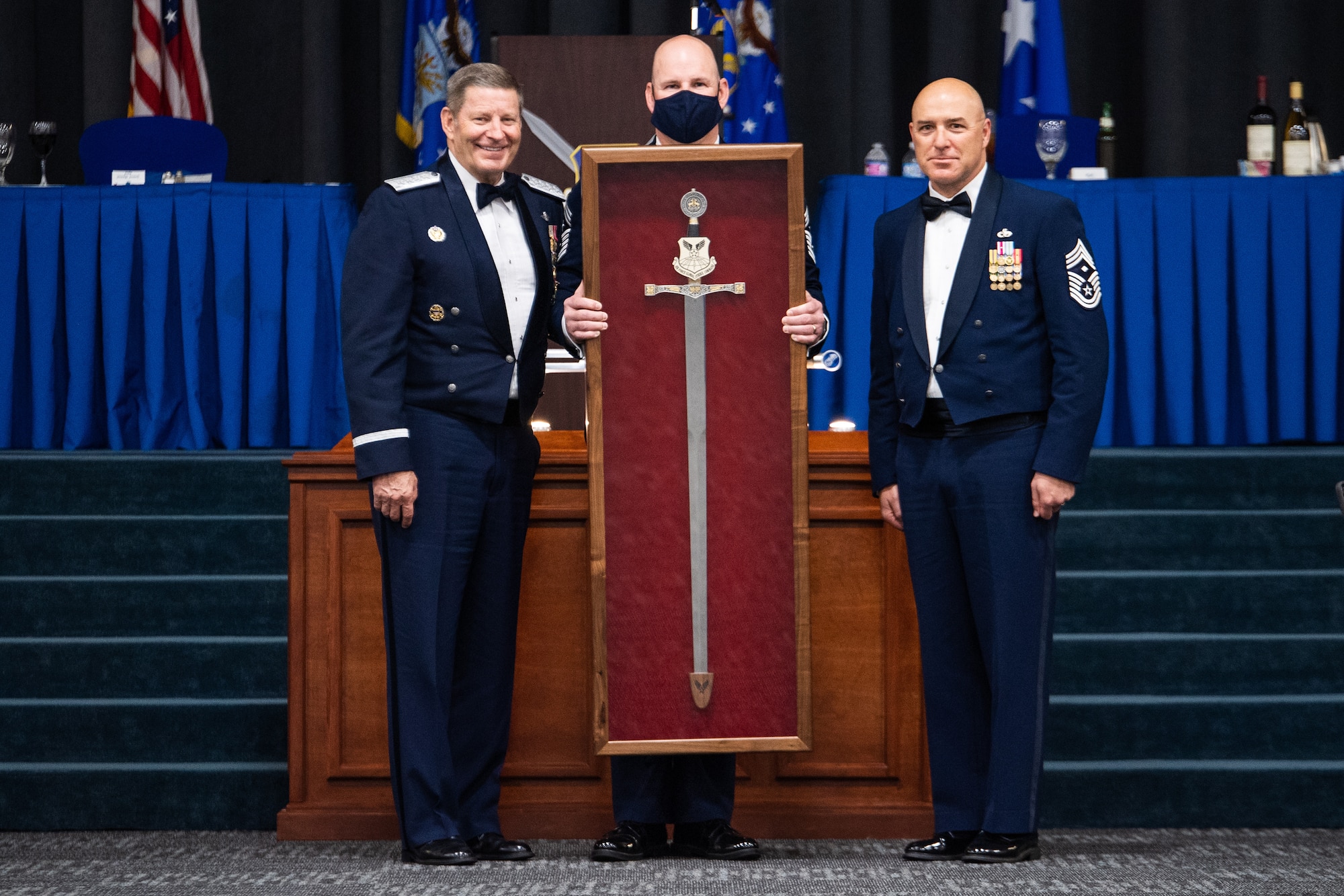 Chief Master Sgt. Robert Tibi, right, Air Force Global Strike Command command first sergeant, presents the Order of the Sword to retired Gen. Robin Rand, left, former AFGSC commander, at Barksdale Air Force Base, Louisiana, April 23, 2021. The Order of the Sword is an Air Force tradition in which members of the enlisted corps recognize and honor senior officers and civilians who have made significant contributions to the welfare and prestige of the enlisted corps. (U.S. Air Force photo by Airman 1st Class Jacob B. Wrightsman)