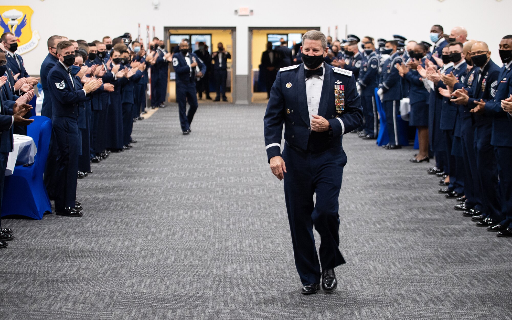 Retired Gen. Robin Rand, former Air Force Global Strike Command commander, is welcomed with a standing ovation during an Order of the Sword ceremony at Barksdale Air Force Base, Louisiana, April 23, 2021. The Order of the Sword is an Air Force tradition in which members of the enlisted corps recognize and honor senior officers and civilians who have made significant contributions to the welfare and prestige of the enlisted corps. (U.S. Air Force photo by Airman 1st Class Jacob B. Wrightsman)