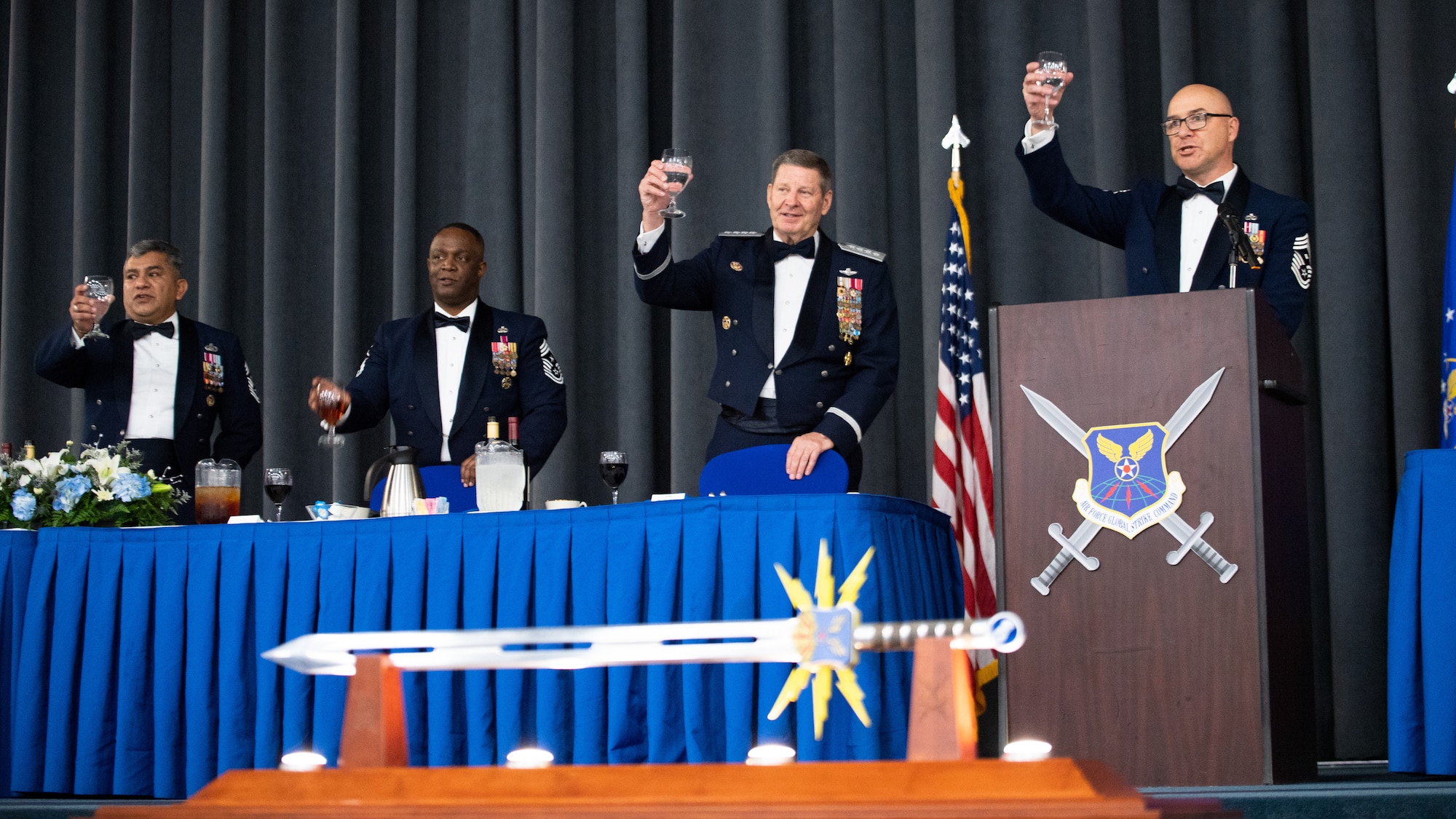 Retired Gen. Robin Rand, second from right, former Air Force Global Strike Command commander, and his former Command Chief Master Sgts. make a toast during an Order of the Sword ceremony at Barksdale Air Force Base, Louisiana, April 23, 2021. The Order of the Sword is a rare honor bestowed on a senior officer or civilian by the enlisted corps of a command. (U.S. Air Force photo by Airman 1st Class Jacob B. Wrightsman)
