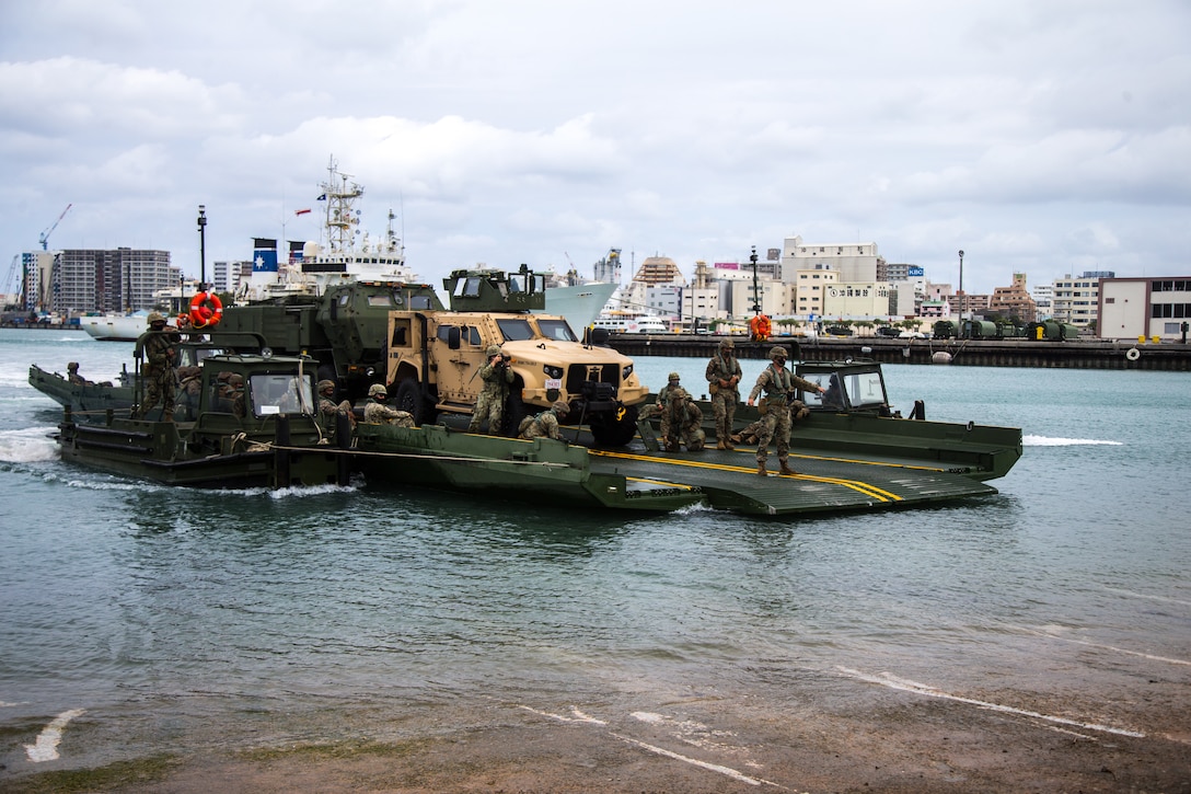 U.S. Marines with 9th Engineer Support Battalion and Navy Seabees with Naval Mobile Construction Battalion 4 transport tactical vehicles on an improved ribbon bridge with 12th Marines, 3d Marine Division during exercise Pacific Pioneer, Naha Port, April 21, 2021. Pacific Pioneer serves as 9th ESB’s Marine Corps Combat Readiness Evaluation as well as an opportunity to demonstrate the ability to sustain expeditionary advanced bases with survivable force protection, practice naval integration, and position long range precision fires and tactical logistics nodes across littoral regions in support of naval operations. (U.S. Marine Corps photo by Lance Cpl. Alyssa Chuluda)