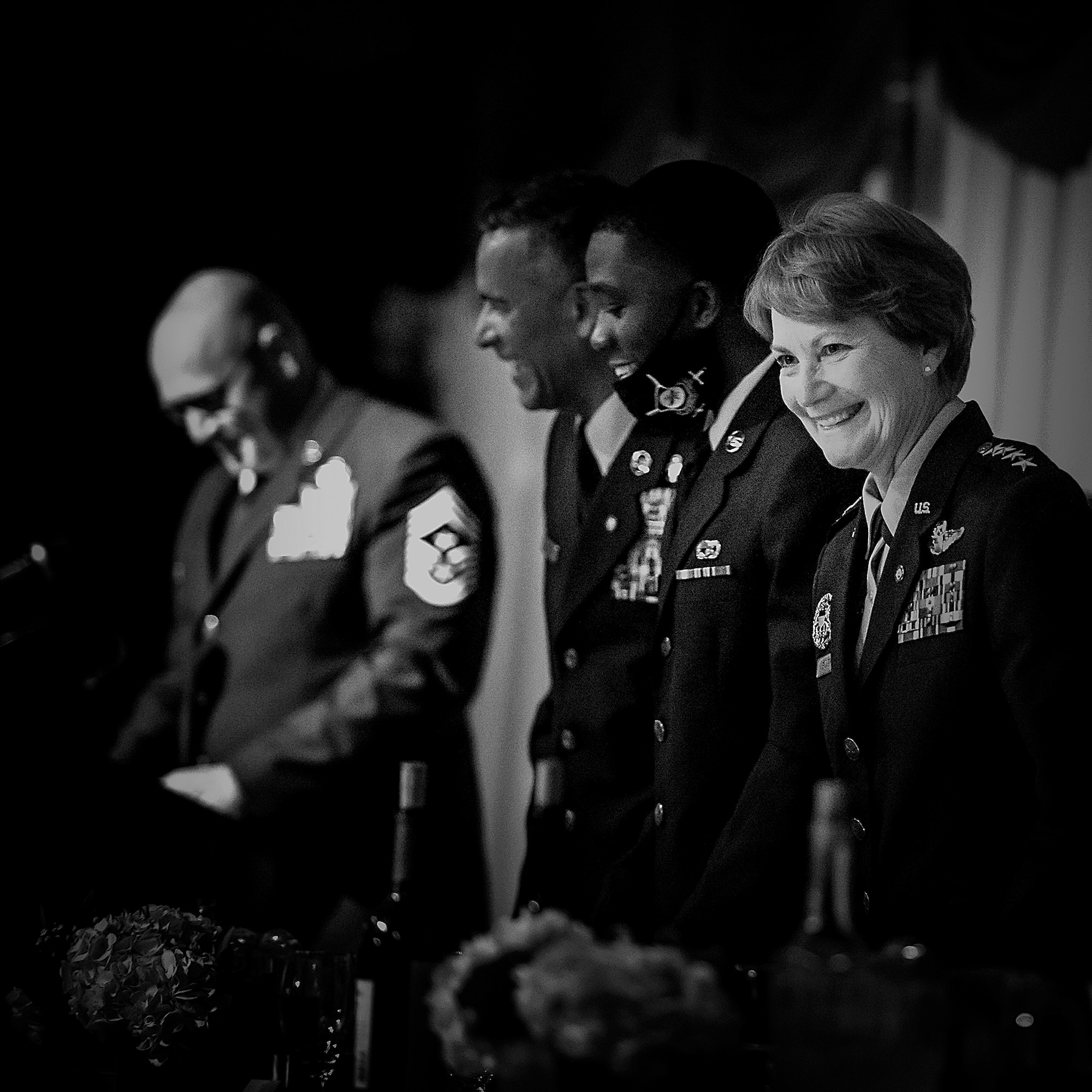 U.S. Air Force Gen., retired, Maryanne Miller, smiles with the audience alongside special guests Airman Aaron Parker and retired Chief Master Sgt. Terry Greene during Air Mobility Command’s Order of the Sword ceremony conducted on her behalf, at Joint Base McGuire-Dix-Lakehurst, N.J, April 23, 2021.