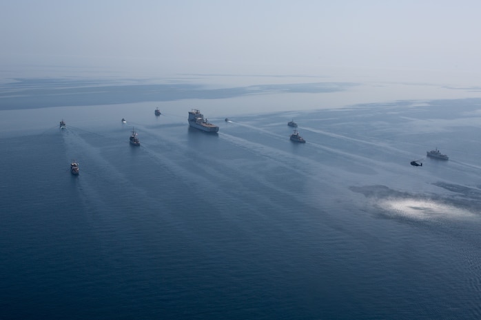 210421-A-BD272-0089 ARABIAN GULF (April 21, 2021) - A multinational group of mine countermeasure ships from the French Marine Nationale, UK Royal Navy, U.S. Navy and a MH-53E Sea Dragon helicopter, attached to the “Blackhawks” of Helicopter Mine Countermeasures Squadron (HM-15), operate in formation during exercise Artemis Trident 21 in the Arabian Gulf, April 21. Artemis Trident 21 is a multilateral mine countermeasures exercise between the UK, Australia, France and U.S., designed to enhance mutual interoperability and capabilities in mine hunting and clearance, maritime security and dive operations, allowing participating naval forces to effectively develop the necessary skills to address threats to regional security, freedom of navigation and the free flow of commerce. (U.S. Army photo by Spc. Theoren Neal)