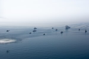210421-A-BD272-0268 ARABIAN GULF (April 21, 2021) - A multinalional group of mine countermeasure ships from the French Marine Nationale, UK Royal Navy, U.S. Navy and a MH-53E Sea Dragon helicopter, attached to the “Blackhawks” of Helicopter Mine Countermeasures Squadron (HM-15), operate in formation during exercise Artemis Trident 21 in the Arabian Gulf, April 21. Artemis Trident 21 is a multilateral mine countermeasures exercise between the UK, Australia, France and U.S., designed to enhance mutual interoperability and capabilities in mine hunting and clearance, maritime security and dive operations, allowing participating naval forces to effectively develop the necessary skills to address threats to regional security, freedom of navigation and the free flow of commerce. (U.S. Army photo by Spc. Theoren Neal)