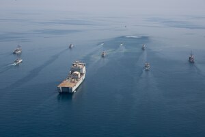 210421-A-BD272-0418 ARABIAN GULF (April 21, 2021) - A multinalional group of mine countermeasure ships from the French Marine Nationale, UK Royal Navy, U.S. Navy and a MH-53E Sea Dragon helicopter, attached to the “Blackhawks” of Helicopter Mine Countermeasures Squadron (HM-15), operate in formation during exercise Artemis Trident 21 in the Arabian Gulf, April 21. Artemis Trident 21 is a multilateral mine countermeasures exercise between the UK, Australia, France and U.S., designed to enhance mutual interoperability and capabilities in mine hunting and clearance, maritime security and dive operations, allowing participating naval forces to effectively develop the necessary skills to address threats to regional security, freedom of navigation and the free flow of commerce. (U.S. Army photo by Spc. Theoren Neal)