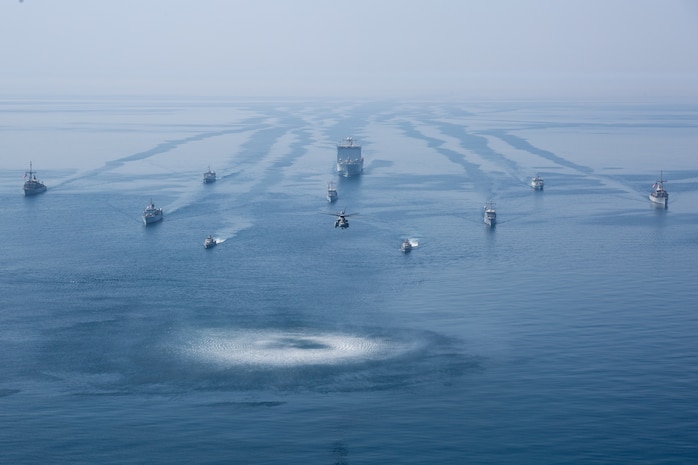 210425-A-IY623-0042 ARABIAN GULF (April 25, 2021) – Hospital Corpsman 1st Class Christian Sampson, assigned to mine countermeasures ship USS Sentry (MCM 3), communicates with the pilot house while conducting an air defense exercise with Helicopter Sea Combat Squadron (HSC) 26, during exercise Artemis Trident 21 in the Arabian Gulf, April 25. Artemis Trident 21 is a multilateral mine countermeasures exercise between the UK, Australia, France and U.S., designed to enhance mutual interoperability and capabilities in mine hunting and clearance, maritime security and dive operations, allowing participating naval forces to effectively develop the necessary skills to address threats to regional security, freedom of navigation and the free flow of commerce. (U.S. Army photo by Spc. Evens Milcette Jr.)