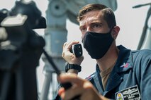 210425-A-IY623-0042 ARABIAN GULF (April 25, 2021) – Hospital Corpsman 1st Class Christian Sampson, assigned to mine countermeasures ship USS Sentry (MCM 3), communicates with the pilot house while conducting an air defense exercise with Helicopter Sea Combat Squadron (HSC) 26, during exercise Artemis Trident 21 in the Arabian Gulf, April 25. Artemis Trident 21 is a multilateral mine countermeasures exercise between the UK, Australia, France and U.S., designed to enhance mutual interoperability and capabilities in mine hunting and clearance, maritime security and dive operations, allowing participating naval forces to effectively develop the necessary skills to address threats to regional security, freedom of navigation and the free flow of commerce. (U.S. Army photo by Spc. Evens Milcette Jr.)