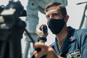 210425-A-IY623-0042 ARABIAN GULF (April 25, 2021) – Hospital Corpsman 1st Class Christian Sampson, assigned to mine countermeasures ship USS Sentry (MCM 3), communicates with the pilot house while conducting an air defense exercise with Helicopter Sea Combat Squadron (HSC) 26, during exercise Artemis Trident 21 in the Arabian Gulf, April 25. Artemis Trident 21 is a multilateral mine countermeasures exercise between the UK, Australia, France and U.S., designed to enhance mutual interoperability and capabilities in mine hunting and clearance, maritime security and dive operations, allowing participating naval forces to effectively develop the necessary skills to address threats to regional security, freedom of navigation and the free flow of commerce. (U.S. Army photo by Spc. Evens Milcette Jr.)