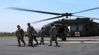 7457th Medical Backfill Battalion personnel carry a simulated casualty to a UH-60 Black Hawk helicopter as part of exercise Guardian Response 21 (GR 21) at Himsel Army Airfield on Camp Atterbury, Indiana, April 27, 2021.