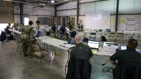 XVIII Airborne Corps Assistant Commanding General, Canadian Brig. Gen. Robert Ritchie talks to Joint Task Force Civil Support personnel, Task Force liaison officers, federal contractors and other stakeholders in the forward joint operations center during exercise Guardian Response 21 (GR 21) on Camp Atterbury, Indiana, April 28, 2021.