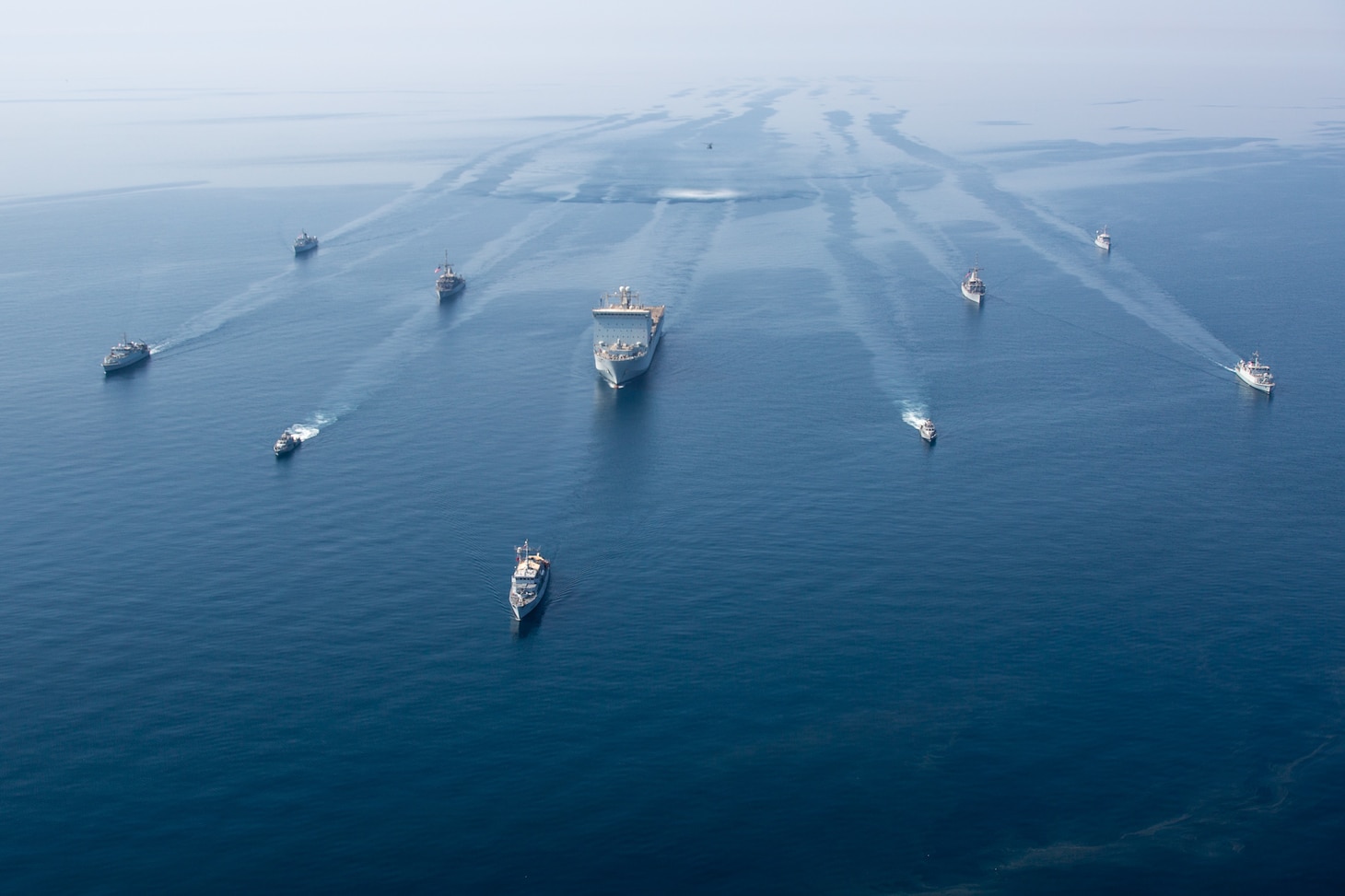 A multinational group of mine countermeasure ships from the French Marine Nationale, UK Royal Navy, U.S. Navy and a MH-53E Sea Dragon helicopter, attached to the “Blackhawks” of Helicopter Mine Countermeasures Squadron (HM-15), operate in formation during exercise Artemis Trident 21 in the Arabian Gulf.