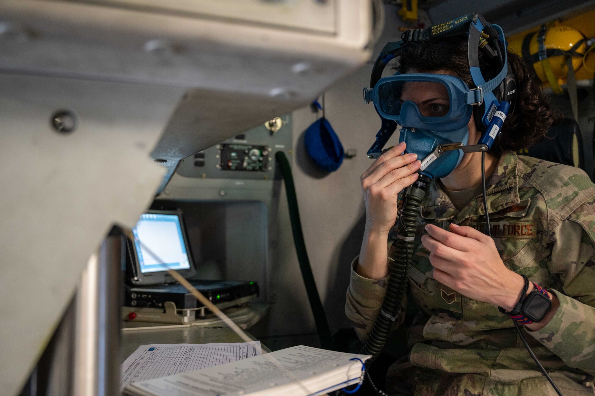 Staff Sgt. Tracey Kolb, 3rd Airlift Squadron loadmaster, tests an oxygen mask on a C-17 Globemaster III before a local training flight at Dover Air Force Base, Delaware, April 22, 2021. The 3rd AS trains to support global engagement through direct delivery of critical theater assets and to ensure combat readiness of Air Mobility Command C-17 aircrews. (U.S. Air Force photo by Airman 1st Class Faith Schaefer)