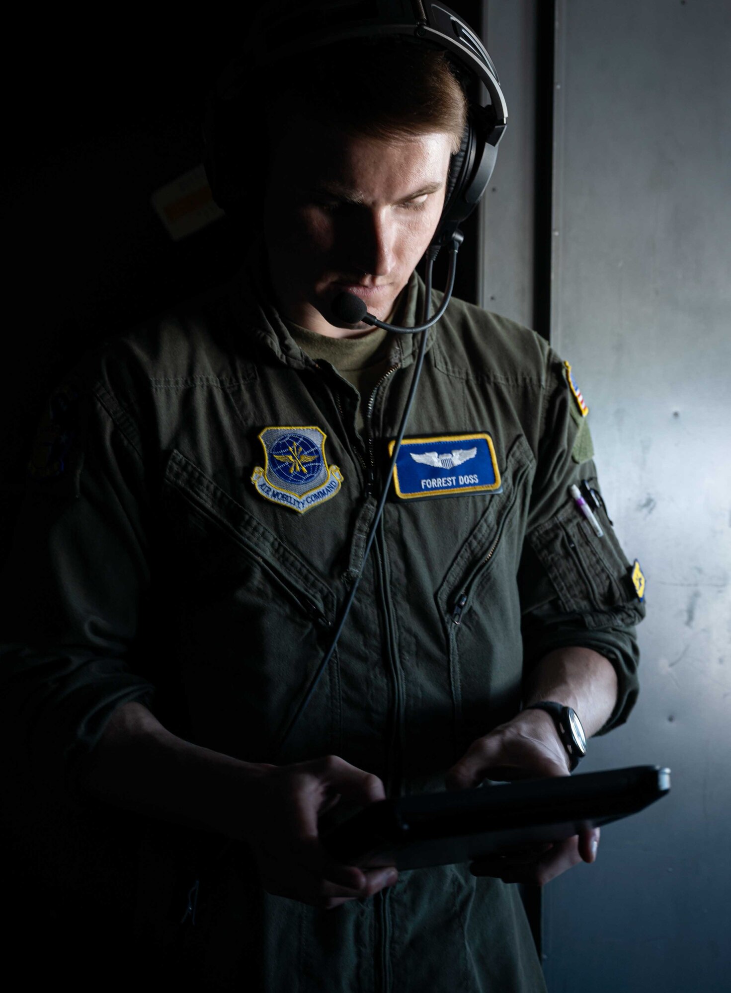 First Lt. Forrest Doss, 3rd Airlift Squadron pilot, reviews and discusses a flight plan while on a C-17 Globemaster III during a local training flight over Ohio, April 22, 2021. The 3rd AS trains to support global engagement through direct delivery of critical theater assets and to ensure combat readiness of Air Mobility Command C-17 aircrews. (U.S. Air Force photo by Airman 1st Class Faith Schaefer)