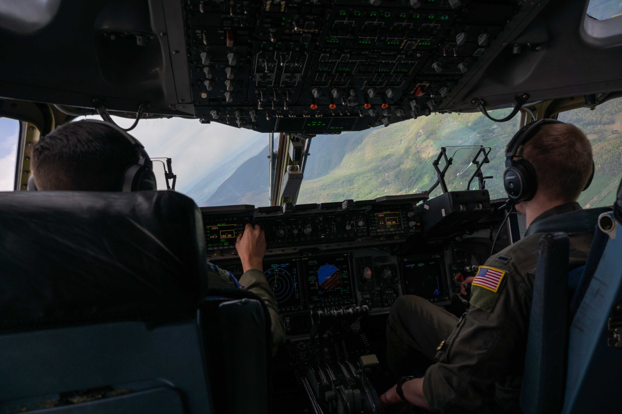 From the left, Capt. Stephen Tice and 1st Lt. Forrest Doss, both 3rd Airlift Squadron pilots, fly a C-17 Globemaster III during a local training flight over Virginia, April 22, 2021. The 3rd AS trains to support global engagement through direct delivery of critical theater assets and to ensure combat readiness of Air Mobility Command C-17 aircrews. (U.S. Air Force photo by Airman 1st Class Faith Schaefer)
