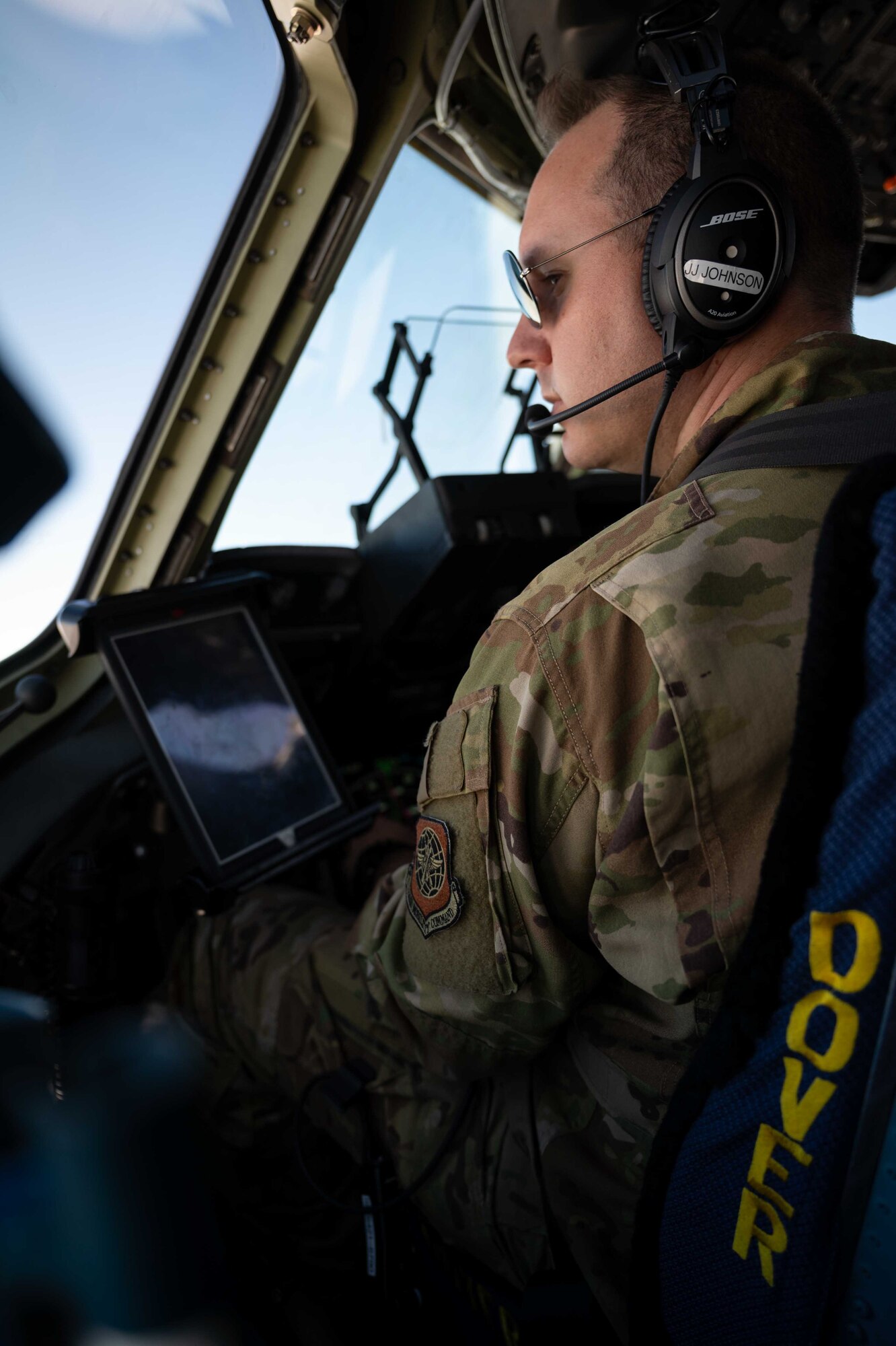 Maj. James Johnson, 3rd Airlift Squadron pilot, looks out the window from the flight deck of a C-17 Globemaster III during a local training flight over Virginia, April 22, 2021. The 3rd AS trains to support global engagement through direct delivery of critical theater assets and to ensure combat readiness of Air Mobility Command C-17 aircrews. (U.S. Air Force photo by Airman 1st Class Faith Schaefer)