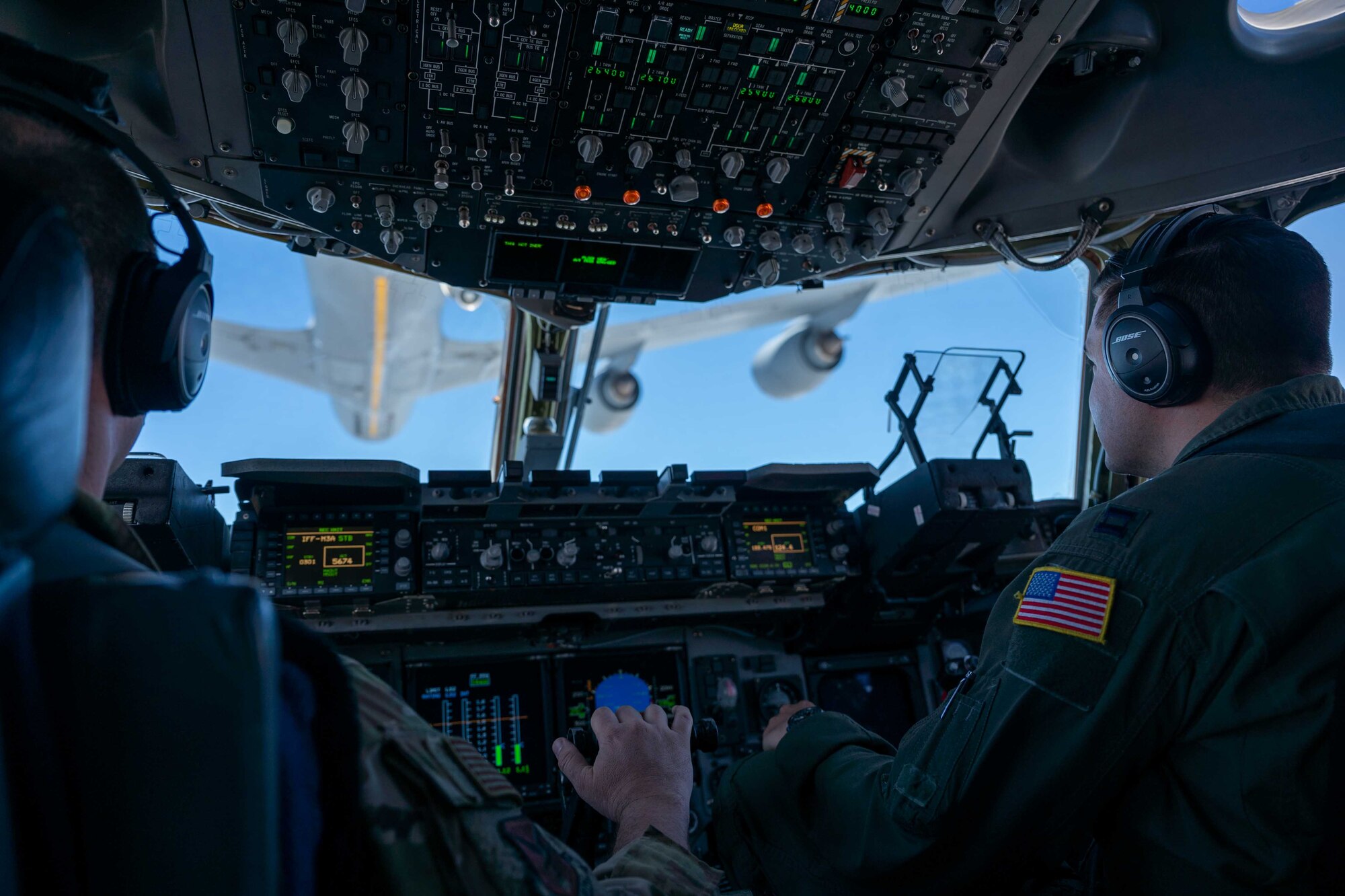 From the left, Maj. James Johnson and Capt. Stephen Tice, both 3rd Airlift Squadron pilots, prepare a C-17 Globemaster III for an aerial refueling from a 171st Air Refueling Wing KC-135 Stratotanker, assigned to the Pennsylvania Air National Guard, during a local training flight over Ohio, April 22, 2021. The 3rd AS trains to support global engagement through direct delivery of critical theater assets and to ensure combat readiness of Air Mobility Command C-17 aircrews. (U.S. Air Force photo by Airman 1st Class Faith Schaefer)