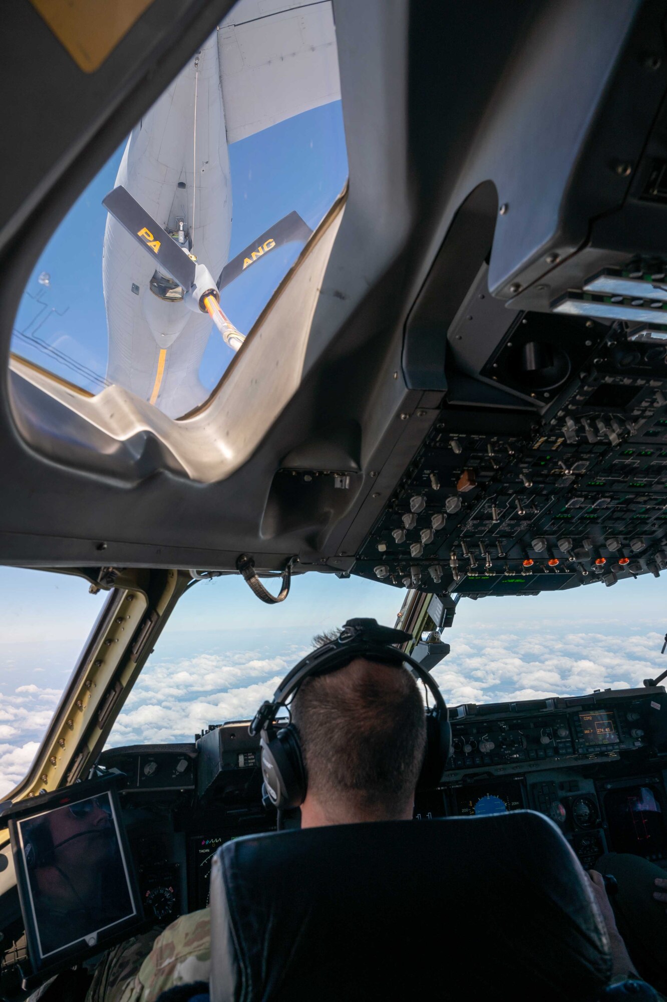 Maj. James Johnson, 3rd Airlift Squadron pilots, prepares a C-17 Globemaster III for an aerial refueling from a 171st Air Refueling Wing KC-135 Stratotanker, assigned to the  Pennsylvania Air National Guard, over Ohio, April 22, 2021. The 3rd AS trains to support global engagement through direct delivery of critical theater assets and to ensure combat readiness of Air Mobility Command C-17 aircrews. (U.S. Air Force photo by Airman 1st Class Faith Schaefer)