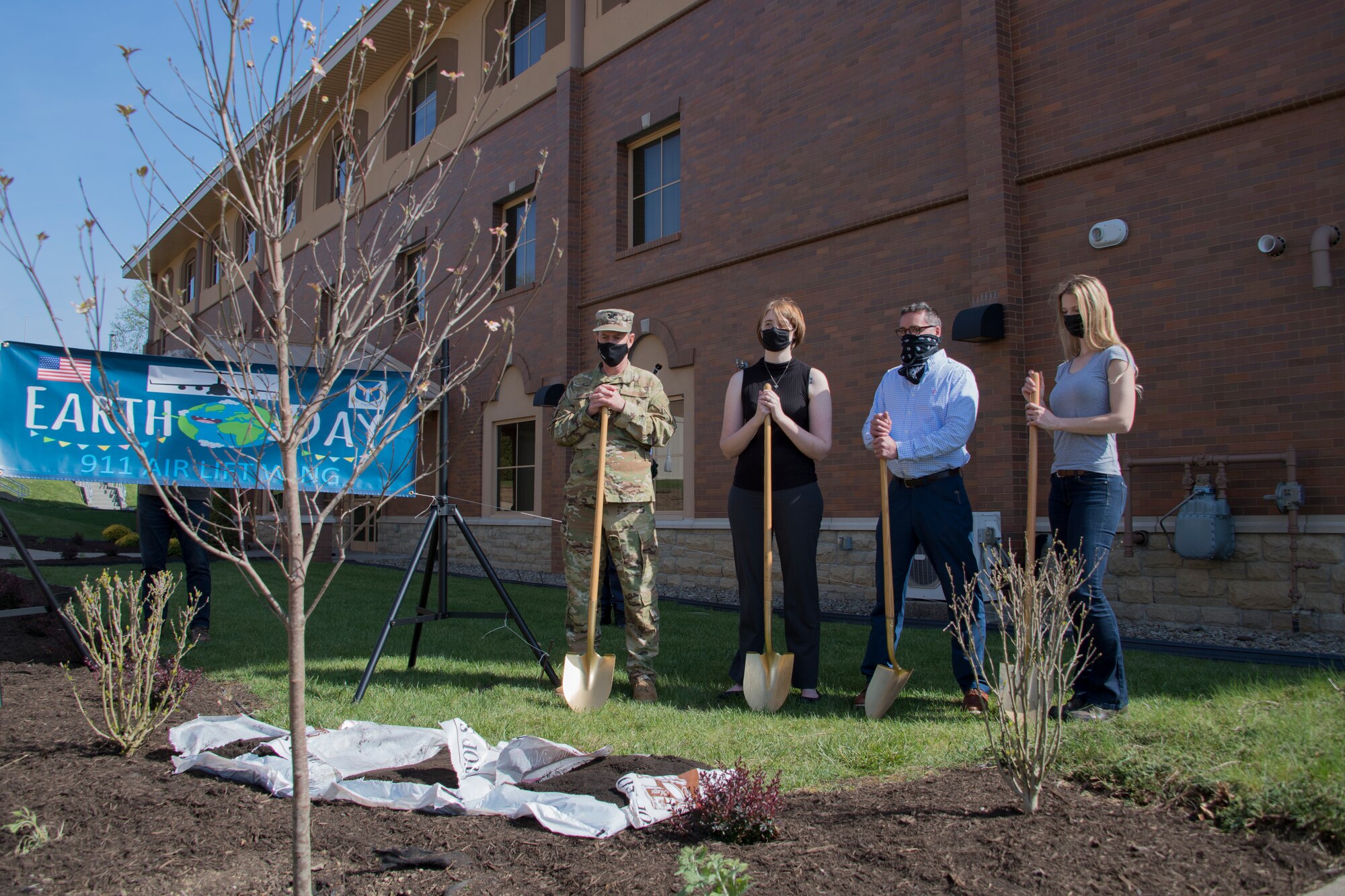 Col. John F. Robinson, commander of the 911th Airlift Wing, Marjorie Schurr, chief of the 911th AW Public Affairs, Charlie Krisfalusi, real property maintenance manager with EAST Operations and Maintenance, and Allison Yeckel, environmental engineer with the 911th Civil Engineering, participate in a tree planting ceremony at the Pittsburgh International Airport Air Reserve Station, Pennsylvania, April 27, 2021.