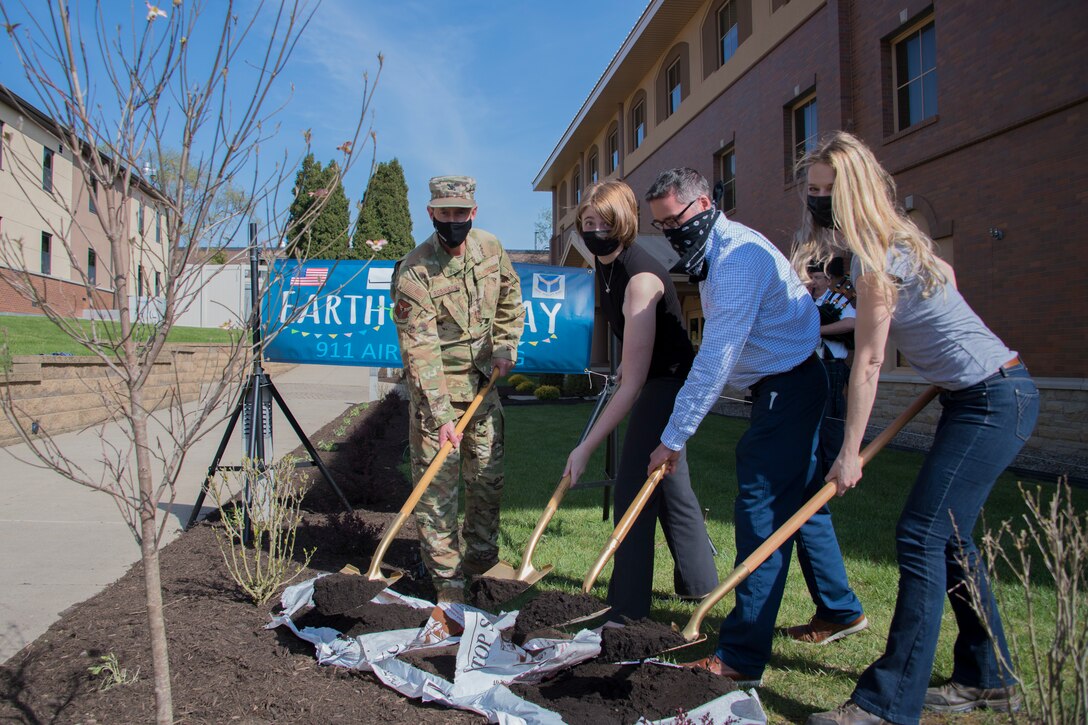 Col. John F. Robinson, commander of the 911th Airlift Wing, Marjorie Schurr, chief of the 911th AW Public Affairs, Charlie Krisfalusi, real property maintenance manager with the EAST Operations and Maintenance, and Allison Yeckel, environmental engineer with the 911th Civil Engineering, participate in a tree planting ceremony at the Pittsburgh International Airport Air Reserve Station, Pennsylvania, April 27, 2021.