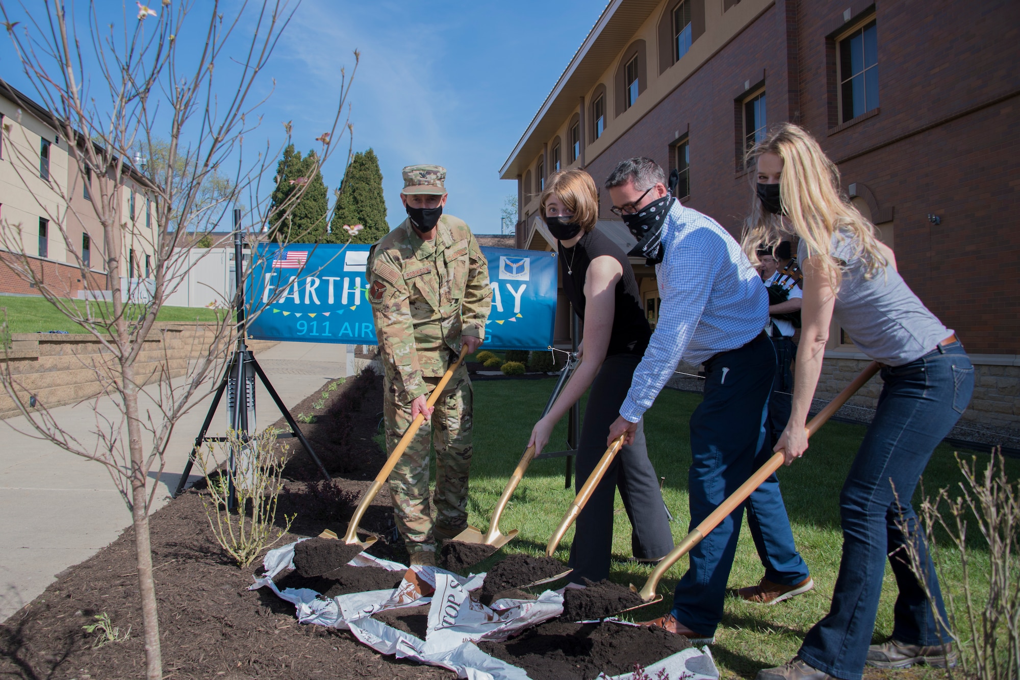 Col. John F. Robinson, commander of the 911th Airlift Wing, Marjorie Schurr, chief of the 911th AW Public Affairs, Charlie Krisfalusi, real property maintenance manager with the EAST Operations and Maintenance, and Allison Yeckel, environmental engineer with the 911th Civil Engineering, participate in a tree planting ceremony at the Pittsburgh International Airport Air Reserve Station, Pennsylvania, April 27, 2021.