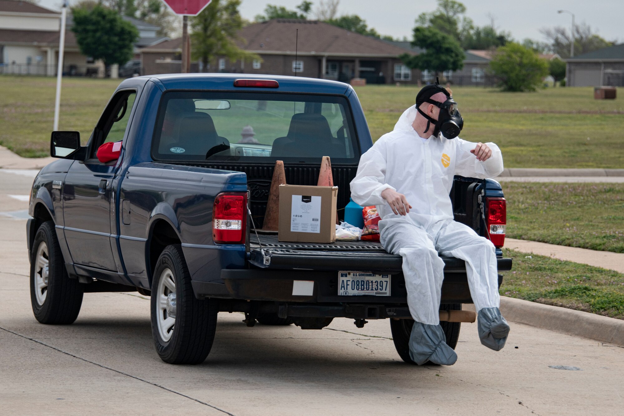 person sits in the back of a truck