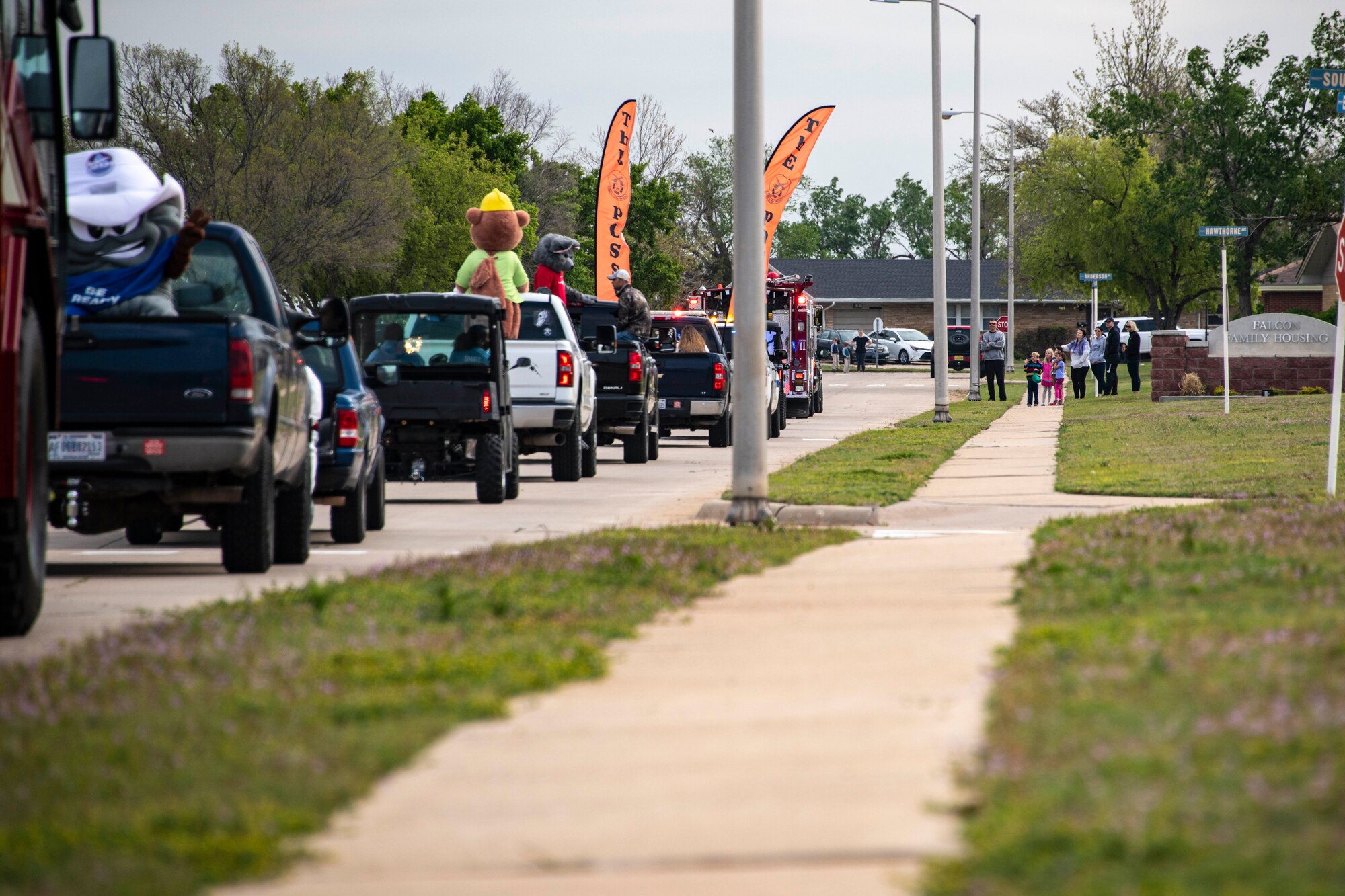 People wave at a parade